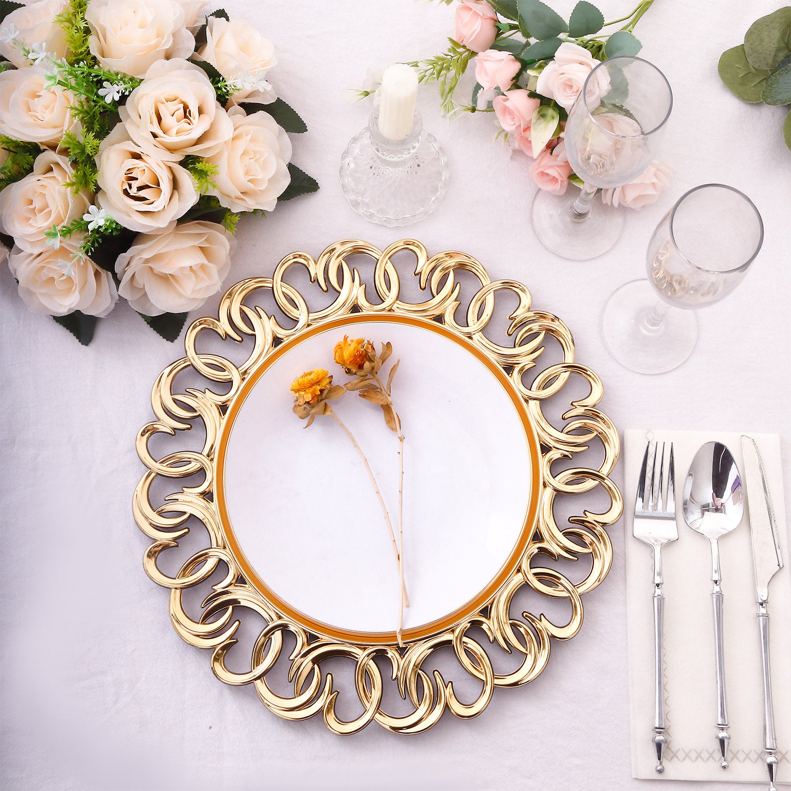 Gold disposable charger plate with entwined swirl rim on a dining table setting.