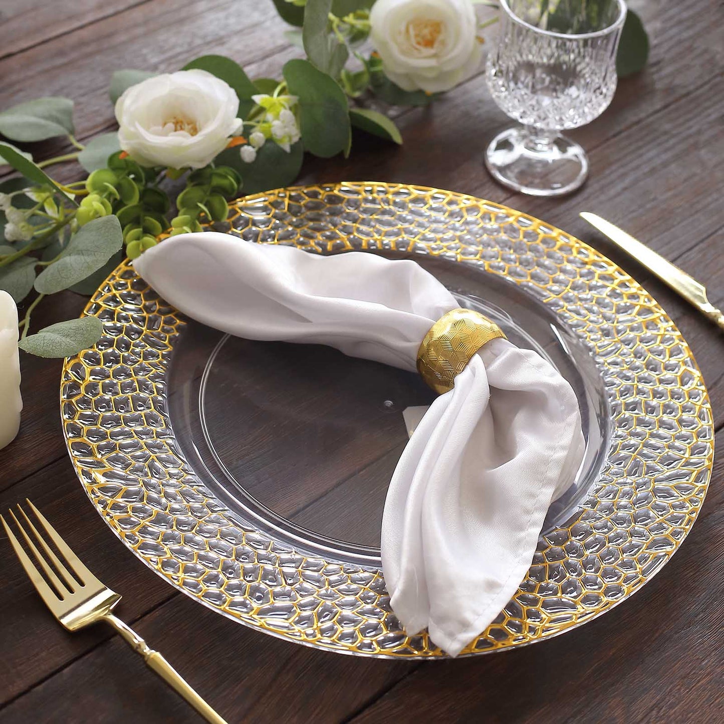 Clear acrylic round charger plate with gold hammered rim.