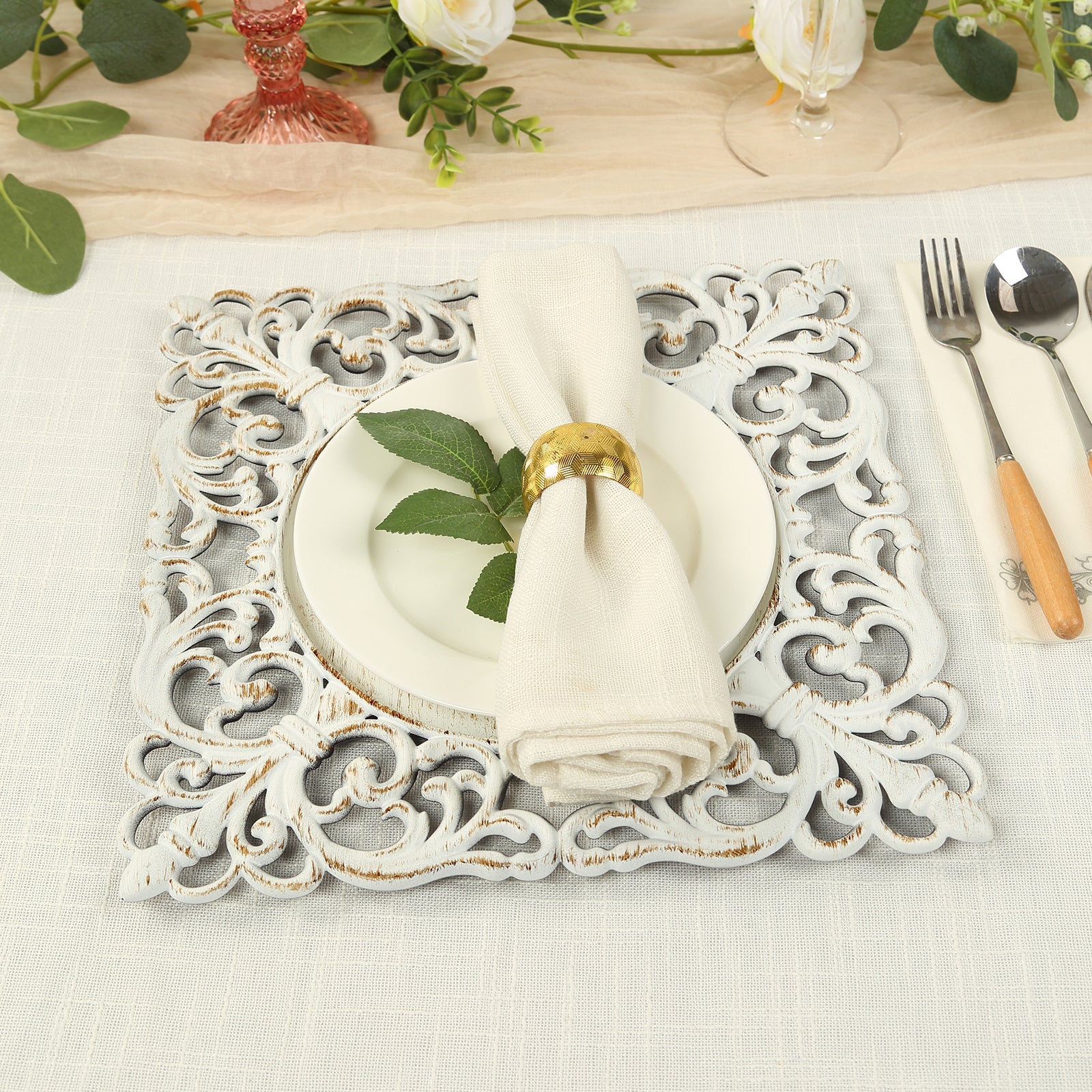 Antique white square acrylic charger plate with lace border on a table setting.