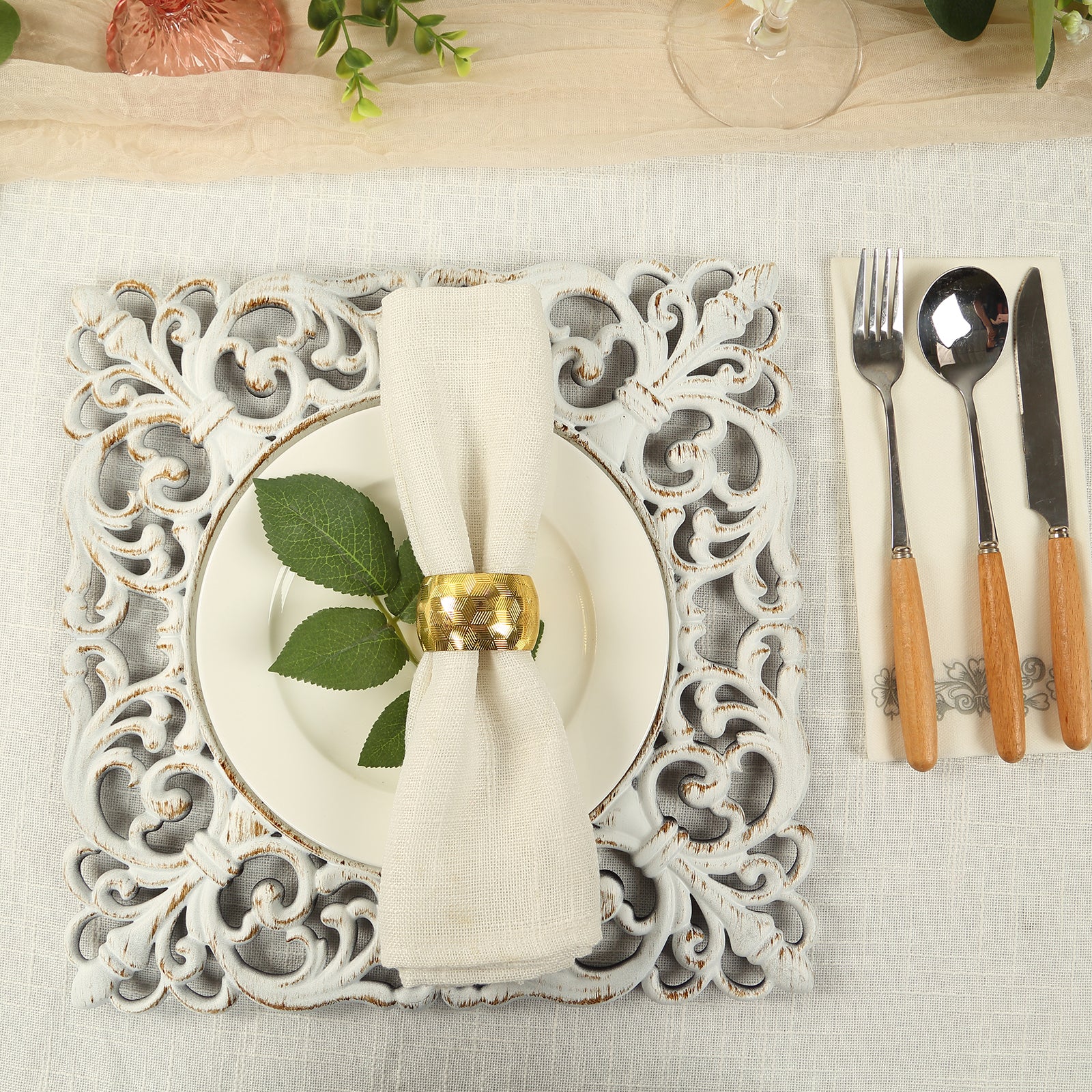 Antique white square acrylic charger plate with lace border on a dining table.