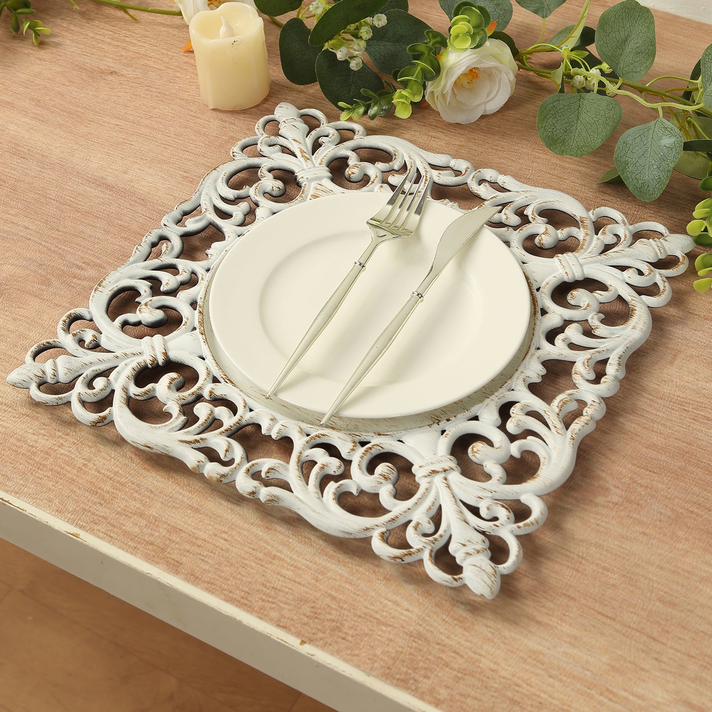 Antique white square acrylic charger plate with lace border on a wooden table.
