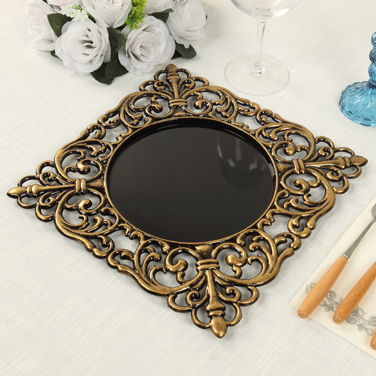 Black square acrylic charger plate with antique gold lace border.