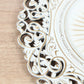 Antique white charger plate with vintage floral carved rim.