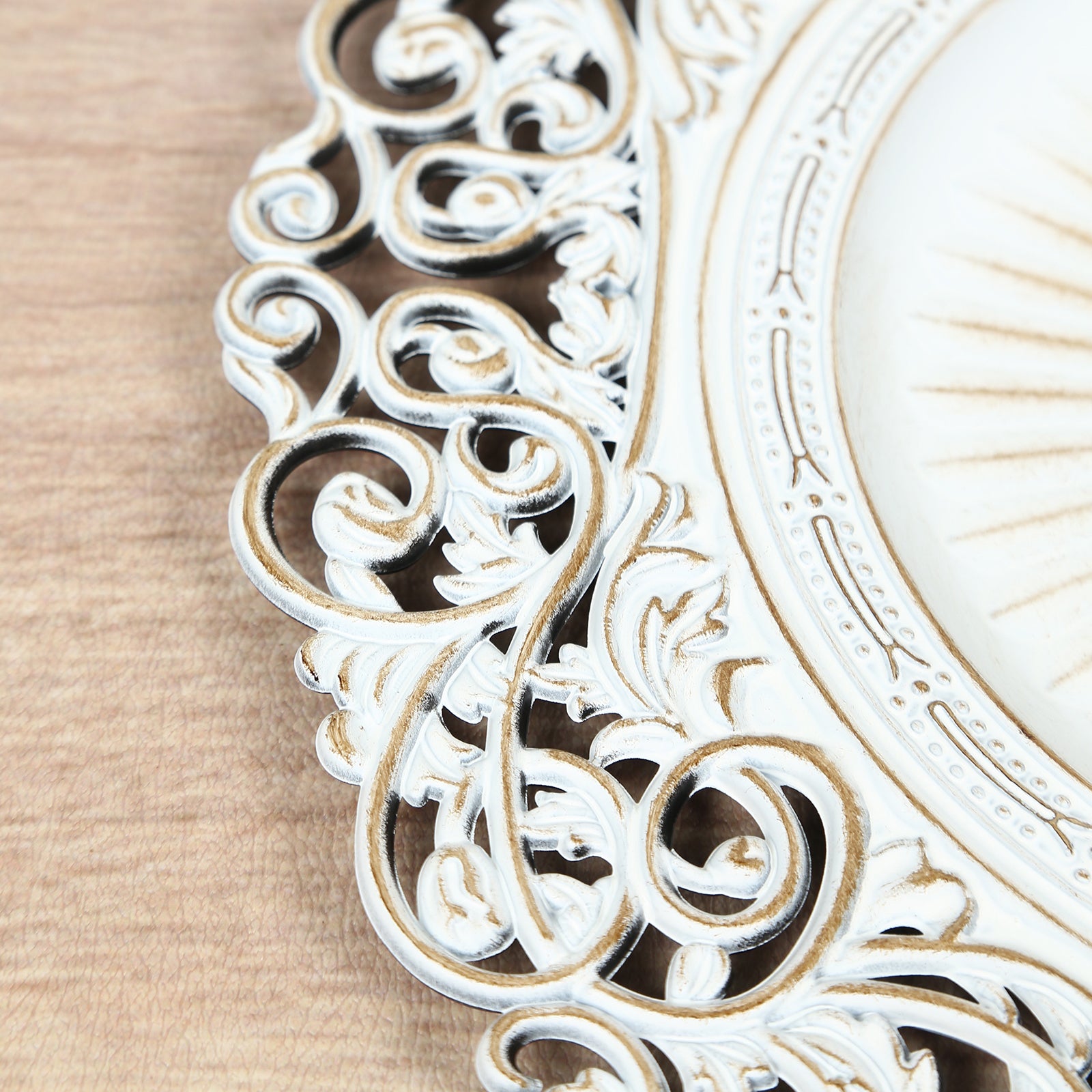 Antique white charger plate with vintage floral carved rim.