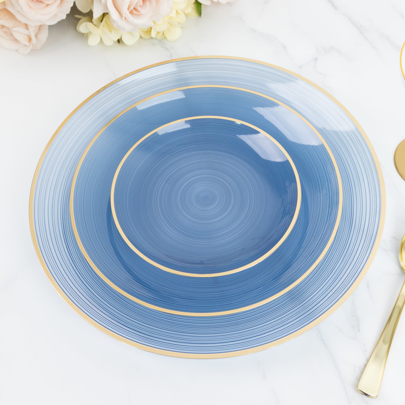 Transparent dusty blue swirl charger plate with gold rim.