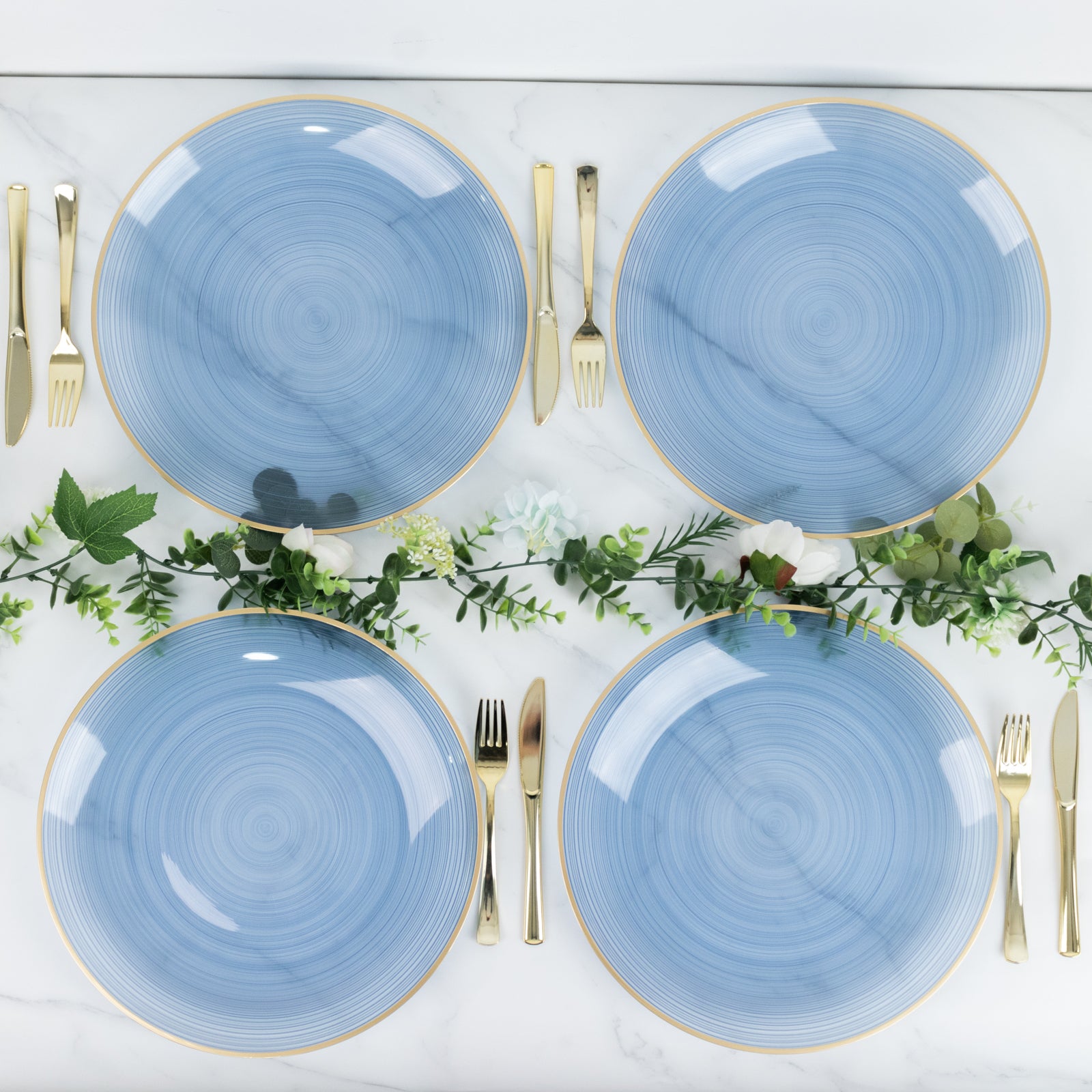 Transparent dusty blue swirl charger plates with gold rim.