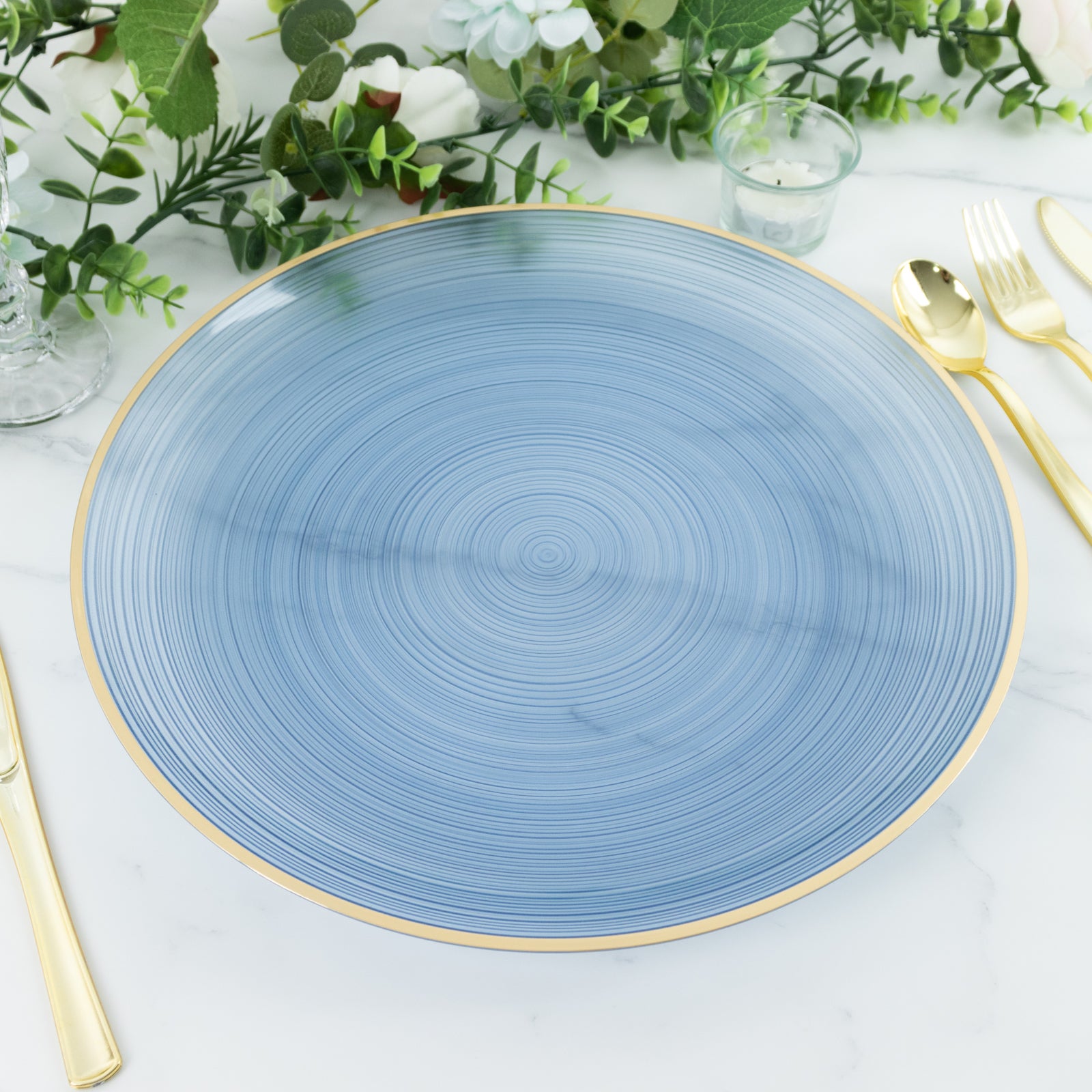 Transparent dusty blue swirl charger plate with gold rim.
