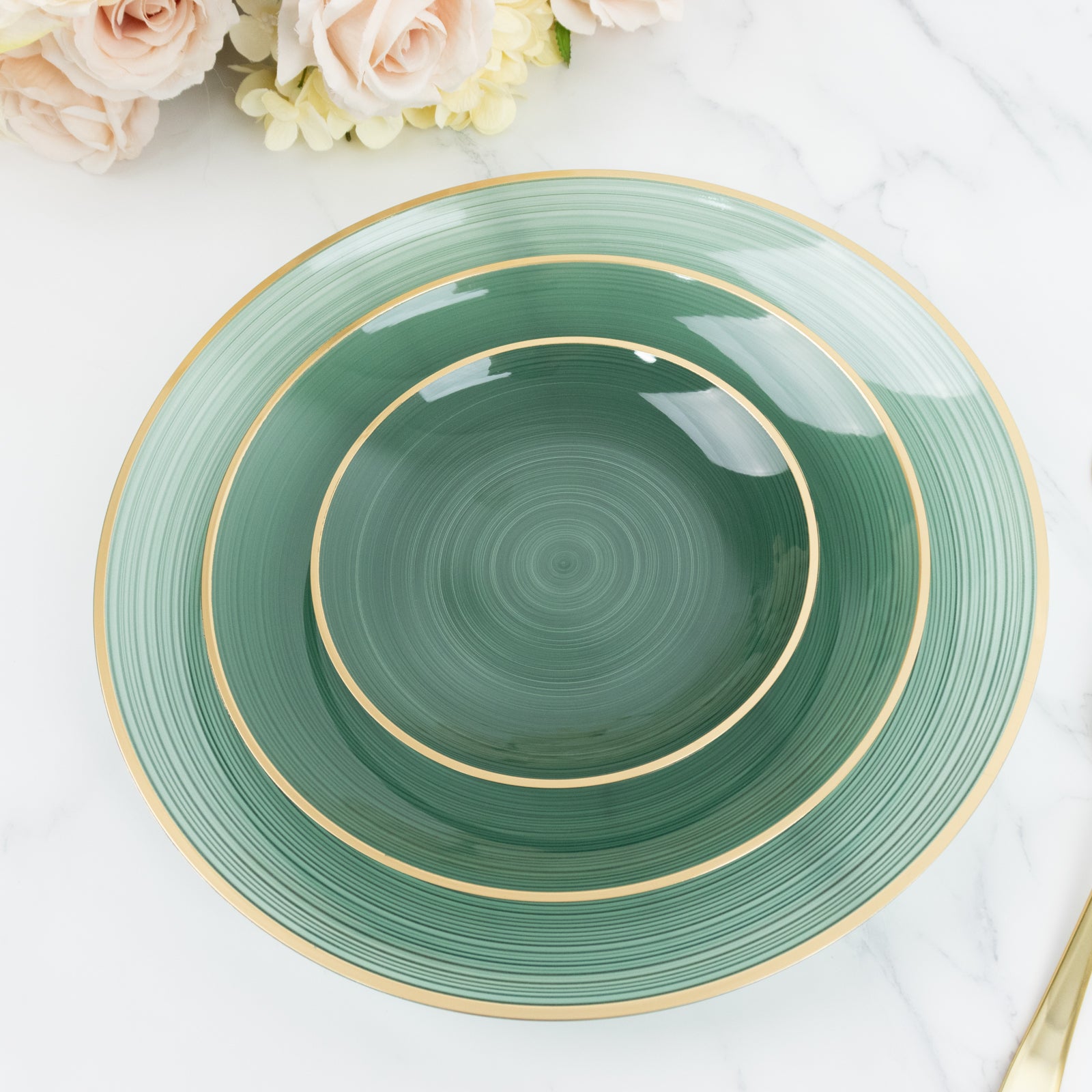 Transparent dusty sage green swirl charger plate with gold rim.