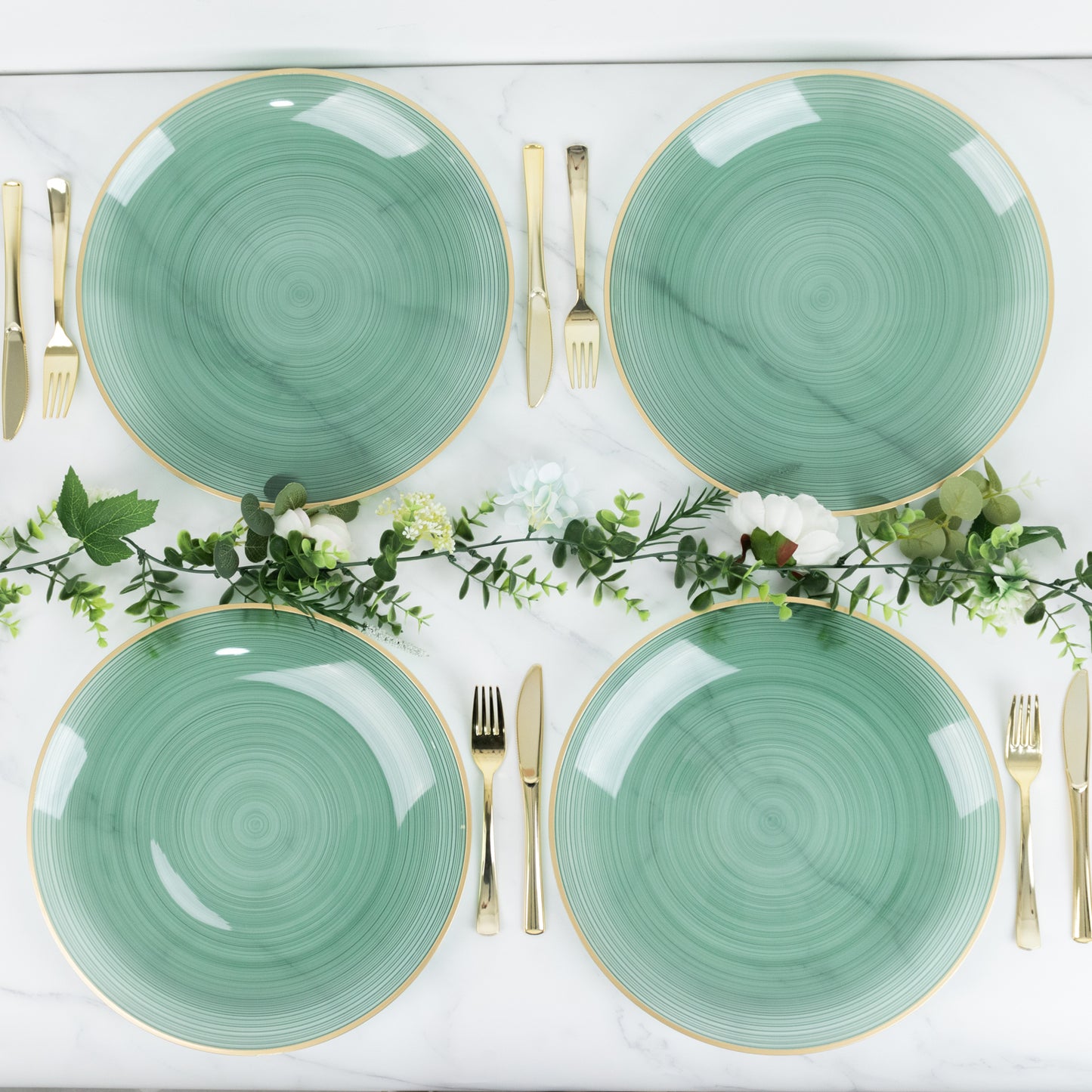 Transparent dusty sage green swirl charger plates with gold rim.