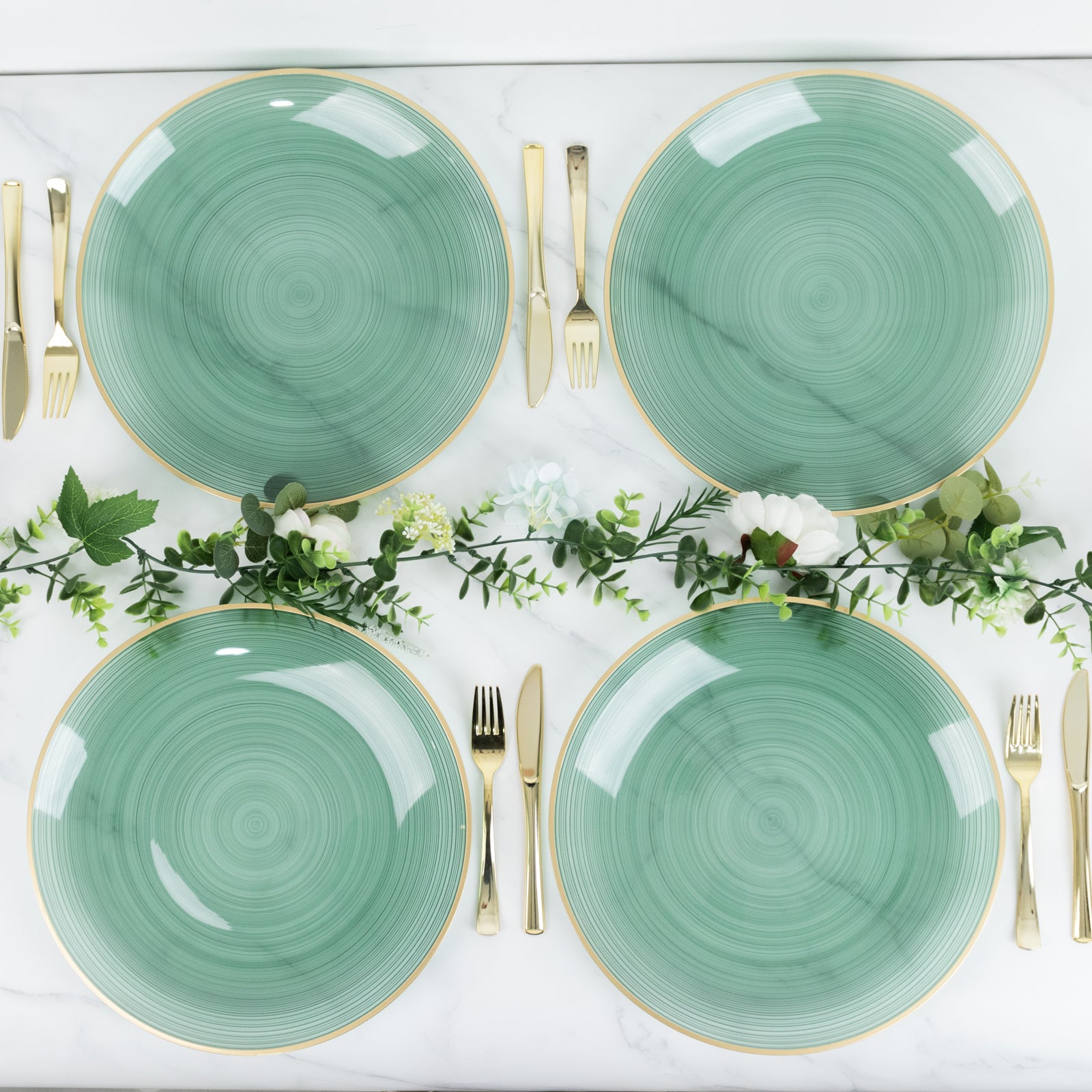 Transparent dusty sage green swirl charger plates with gold rim.
