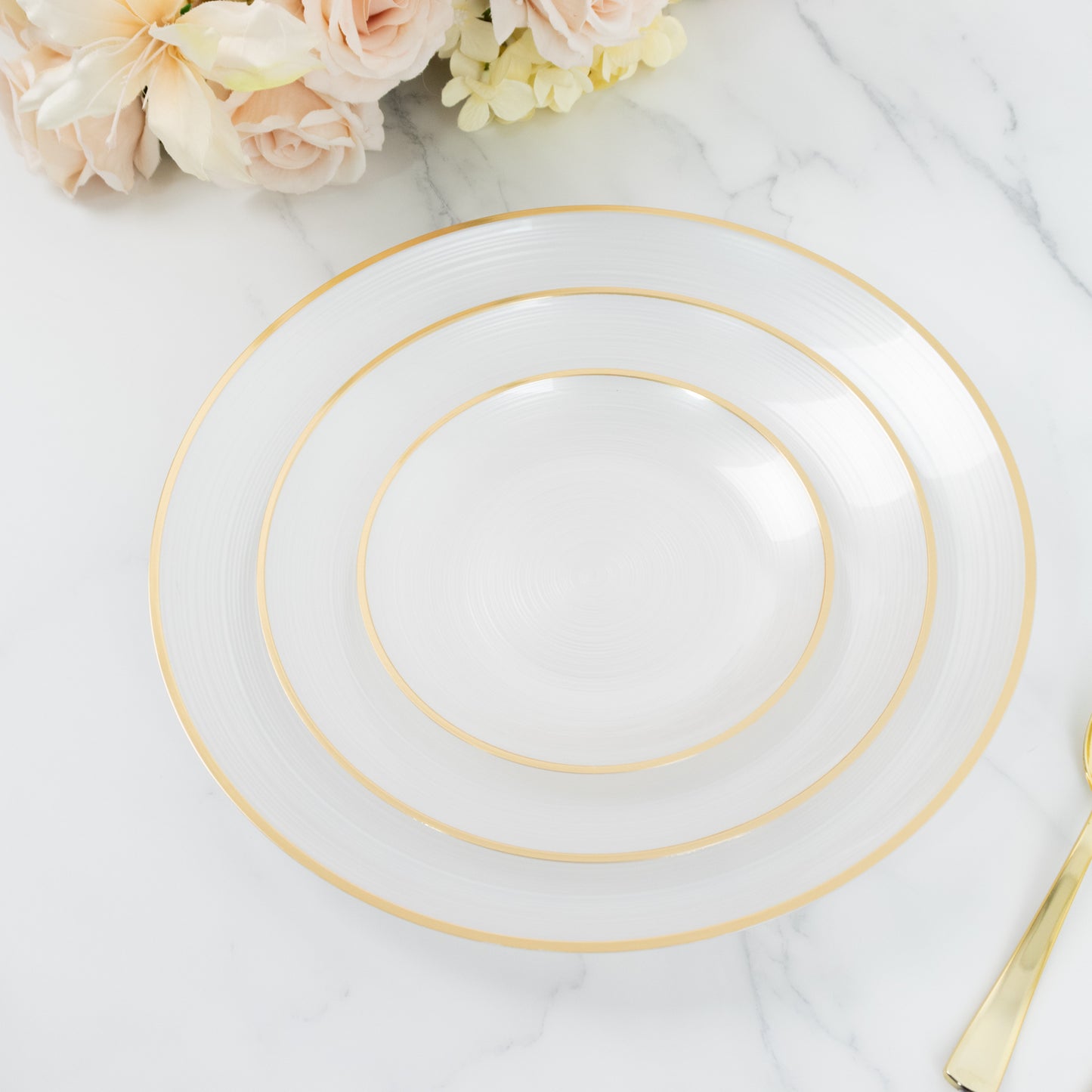 Transparent pearl white swirl charger plate with gold rim.