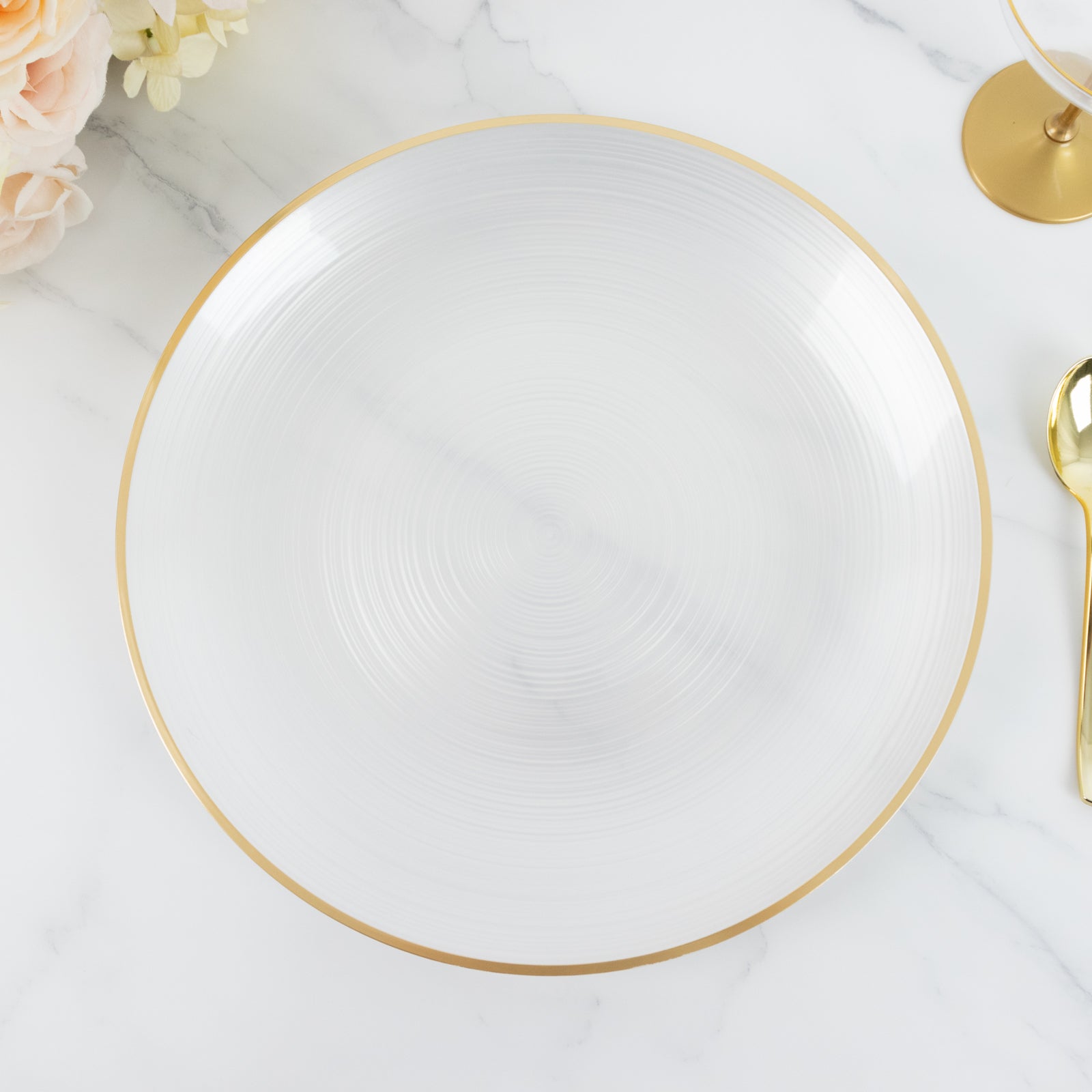 Transparent pearl white swirl charger plate with gold rim.