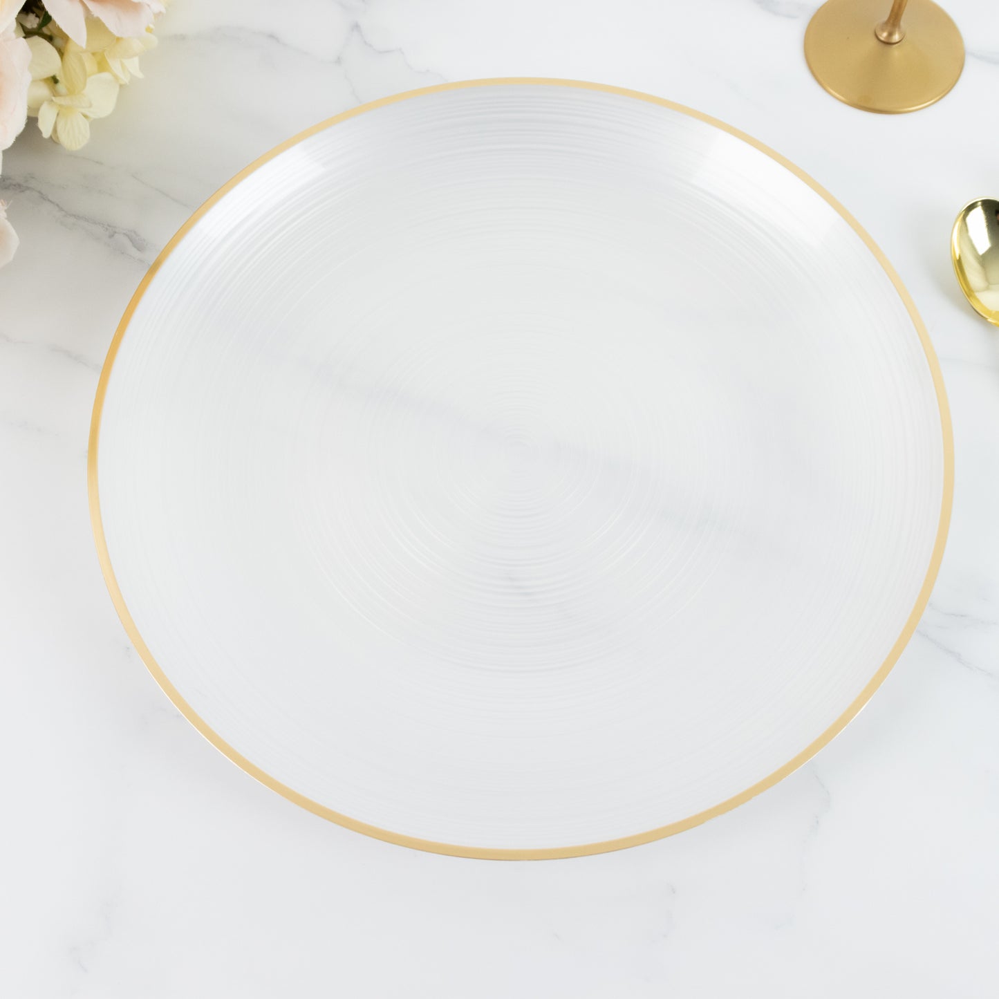 Transparent pearl white swirl charger plate with gold rim.