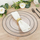 Clear plastic charger plate with black beaded rim, stylish dinner party setting.