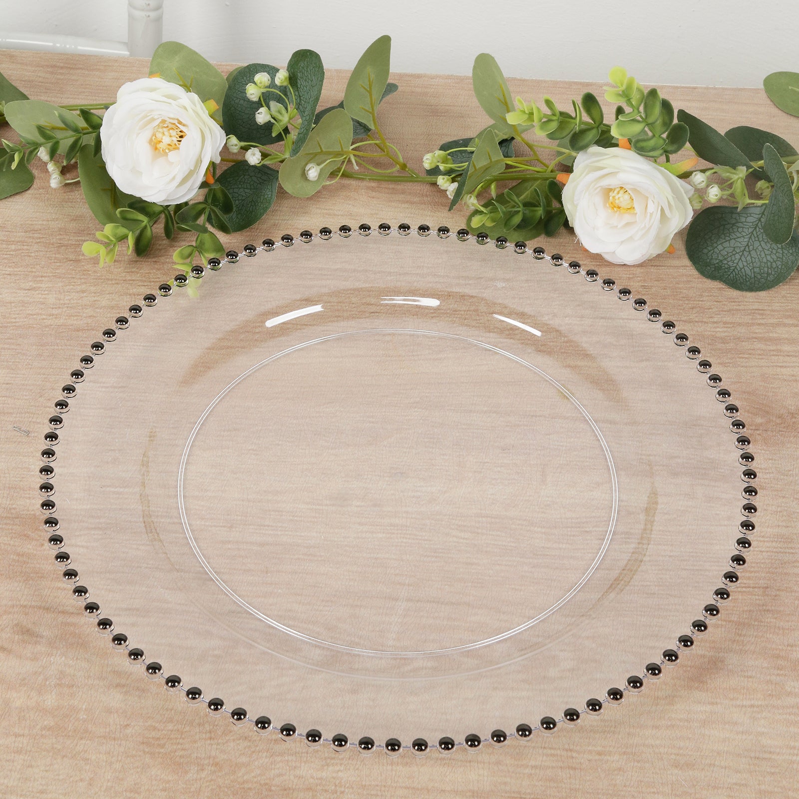 Clear charger plate with black beaded rim for stylish dining.