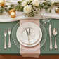 Clear beaded rim charger plates on a styled dinner table setting.