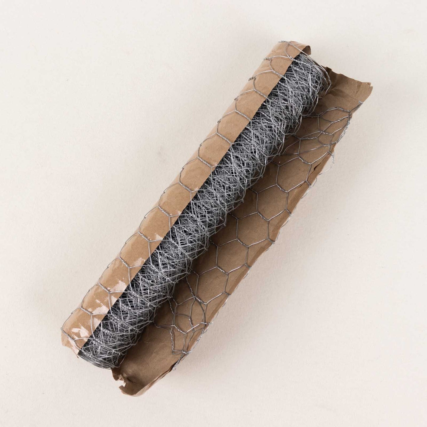 Silver galvanized metal hexagonal chicken wire mesh roll for DIY crafts and garden fencing.