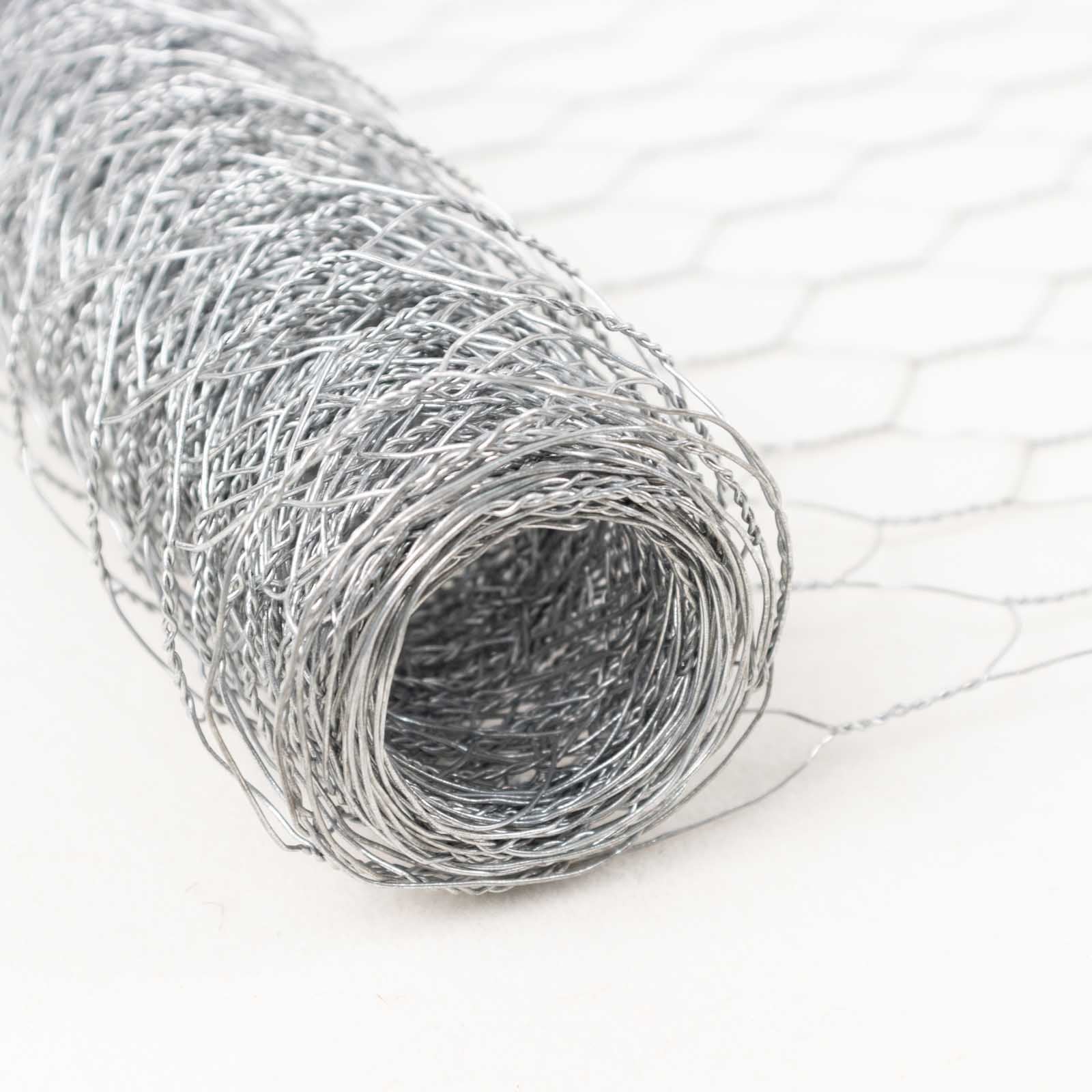 Silver galvanized metal hexagonal chicken wire mesh roll for DIY crafts and garden fencing.