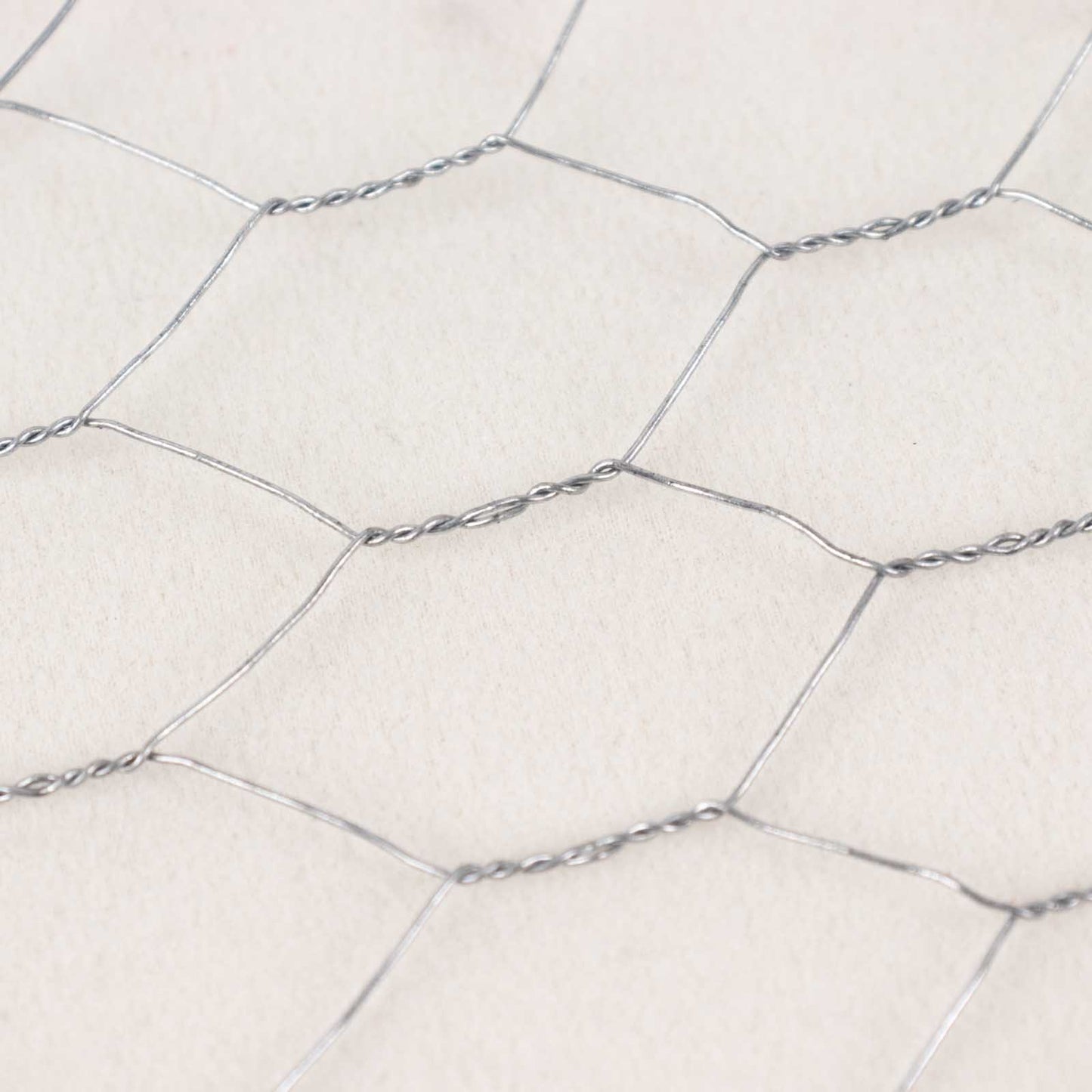Silver galvanized metal hexagonal chicken wire mesh for DIY crafts and garden fencing.