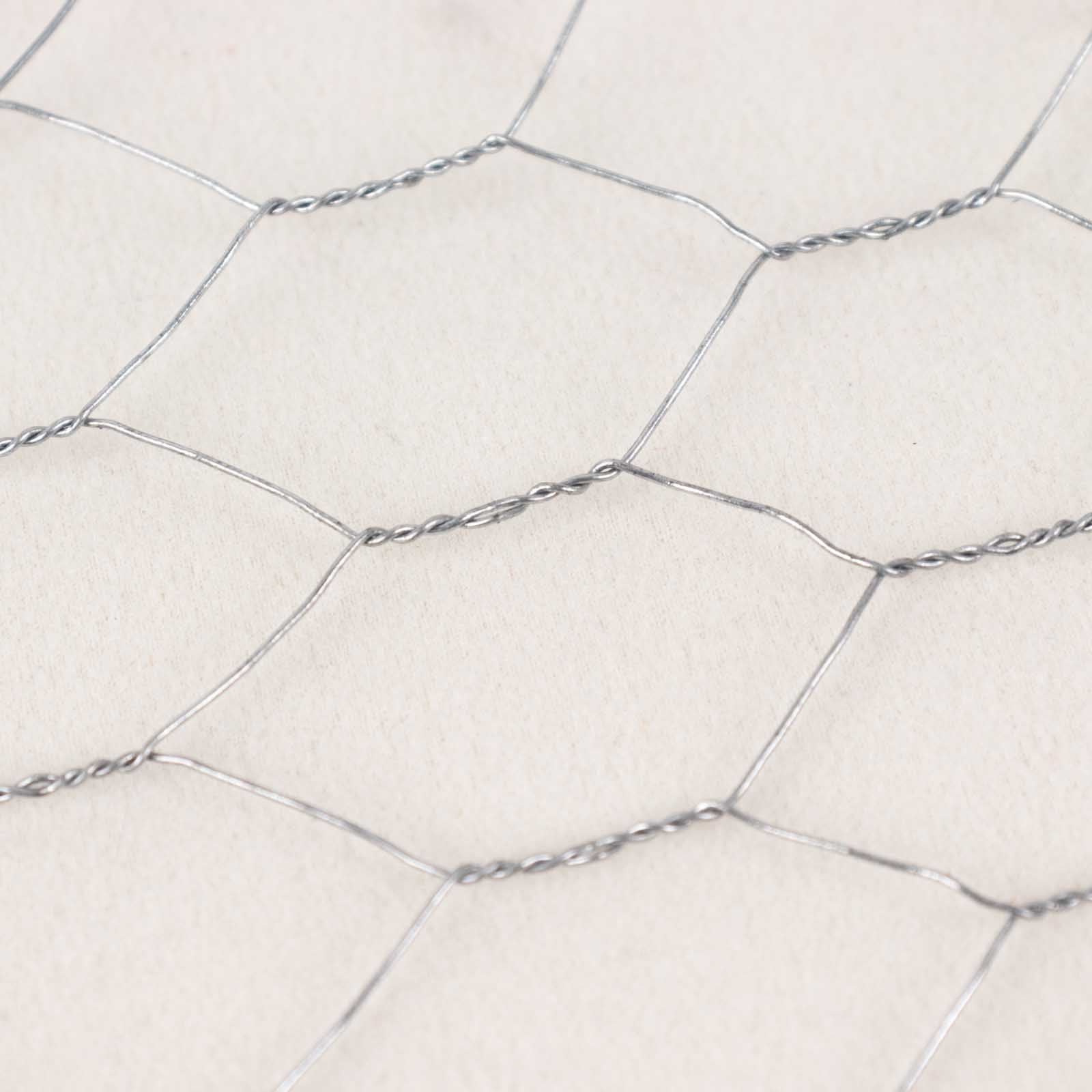 Silver galvanized metal hexagonal chicken wire mesh for DIY crafts and garden fencing.