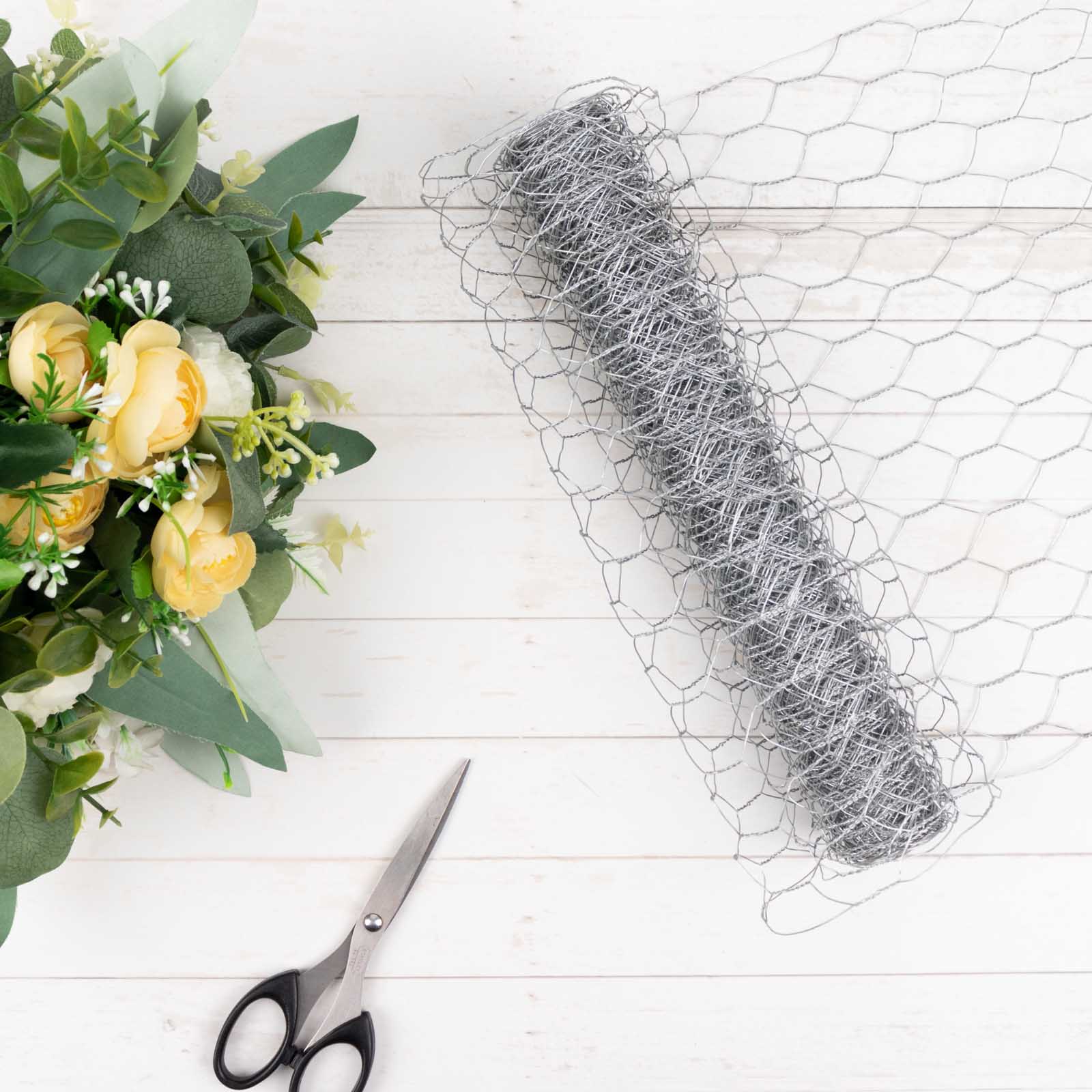 Silver galvanized metal hexagonal chicken wire mesh for DIY crafts and garden fencing.