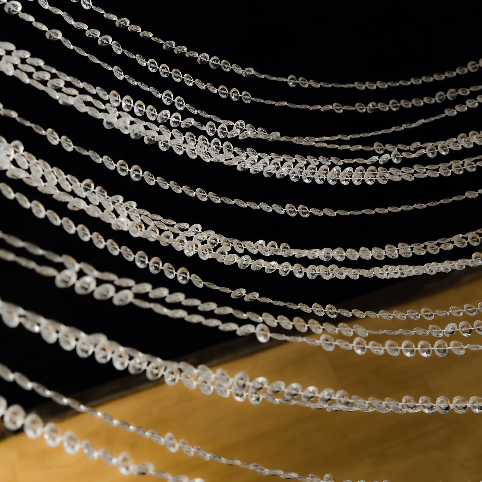 Clear acrylic crystal beaded curtain strands hanging elegantly.