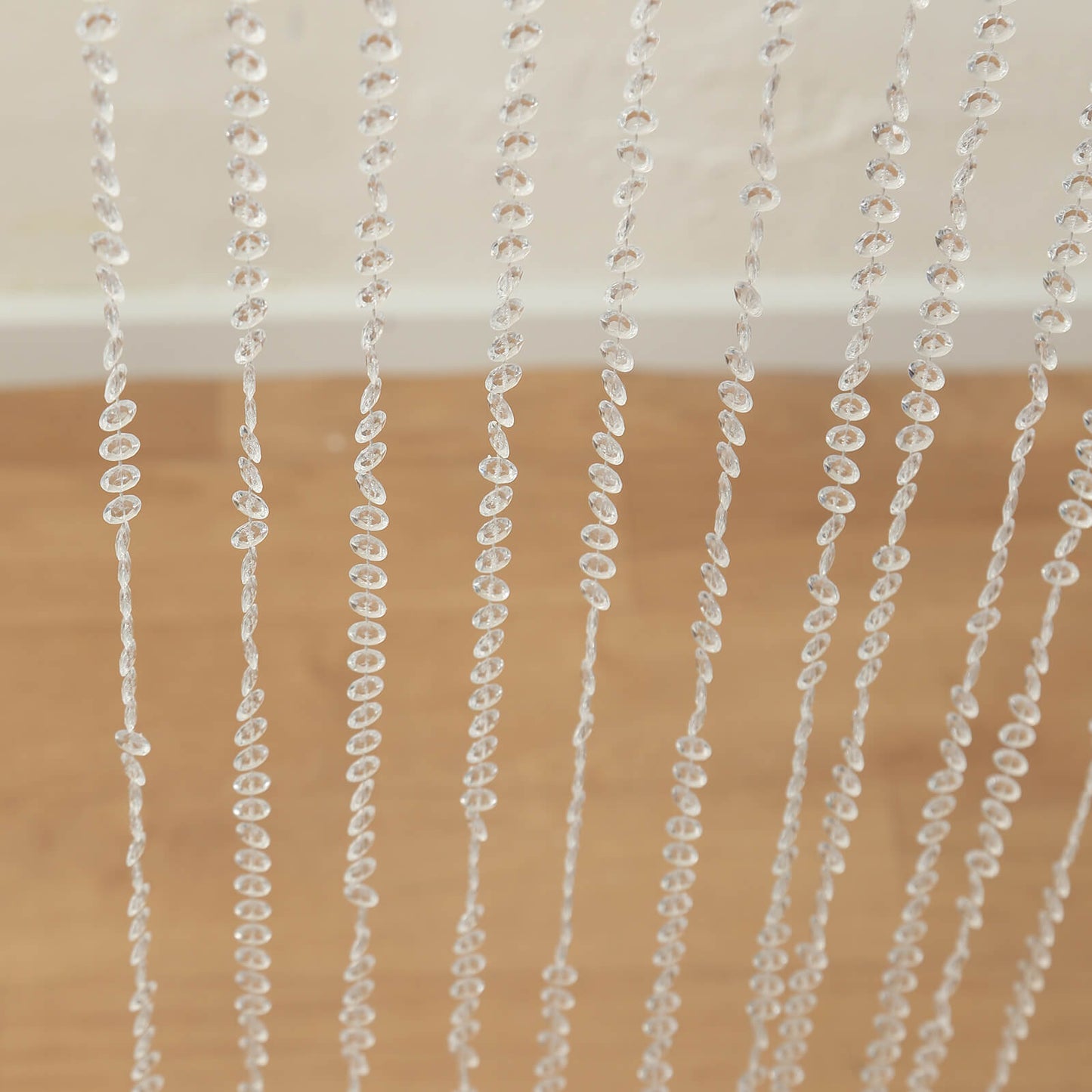 Clear acrylic crystal beaded curtain with diamond cut beads.