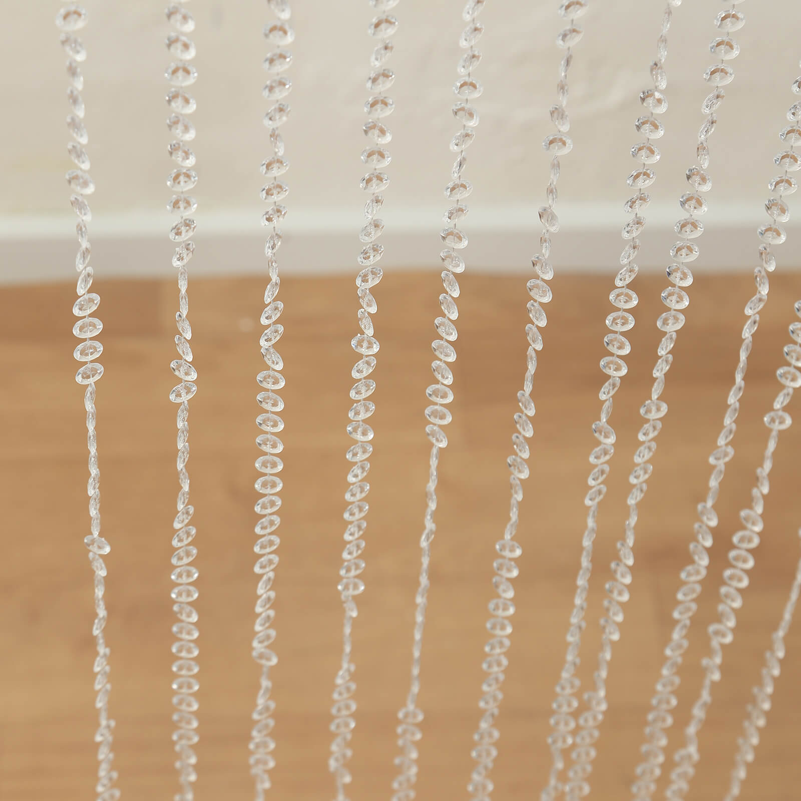 Clear acrylic crystal beaded curtain with diamond cut beads.