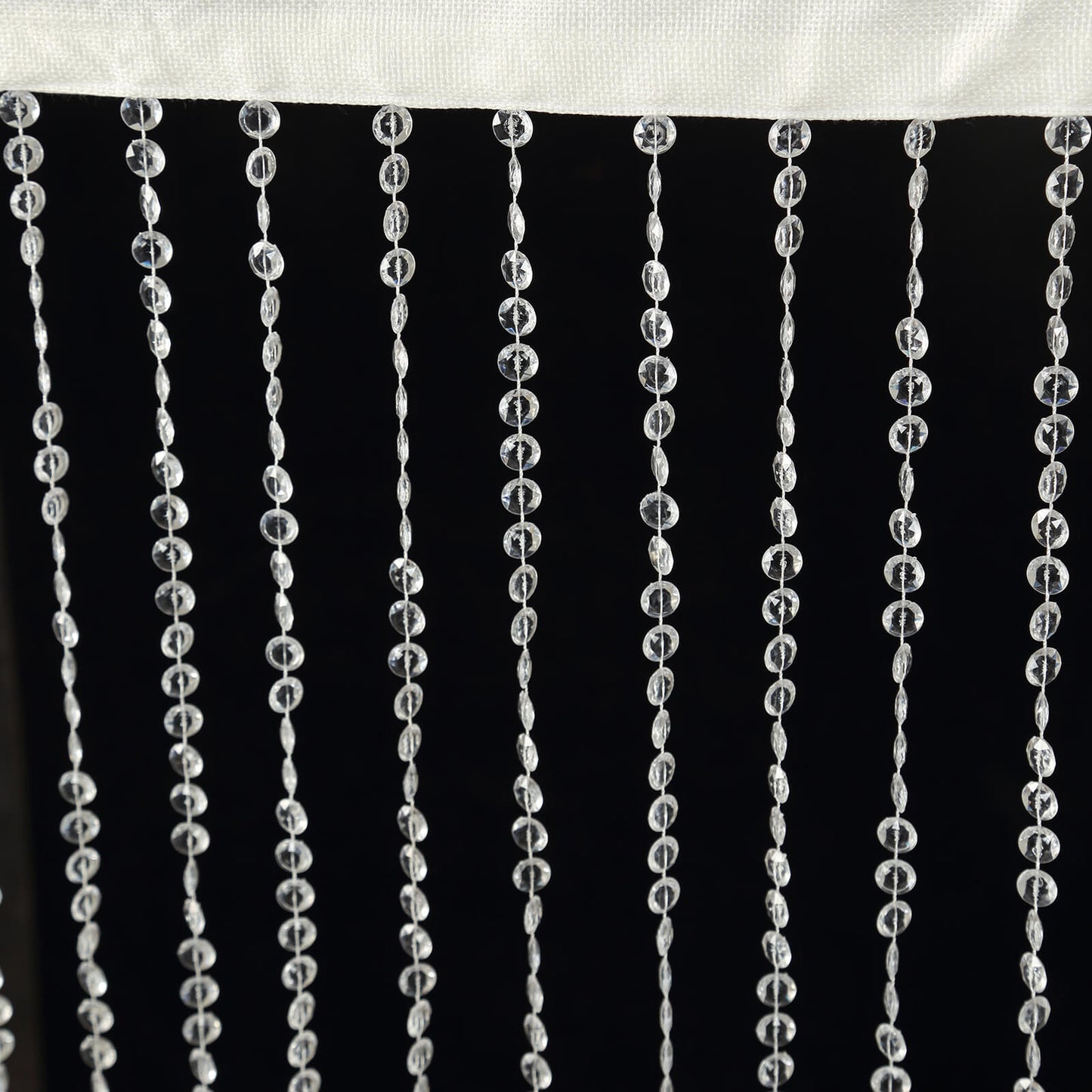 Clear acrylic crystal beaded curtain with fabric rod pocket.
