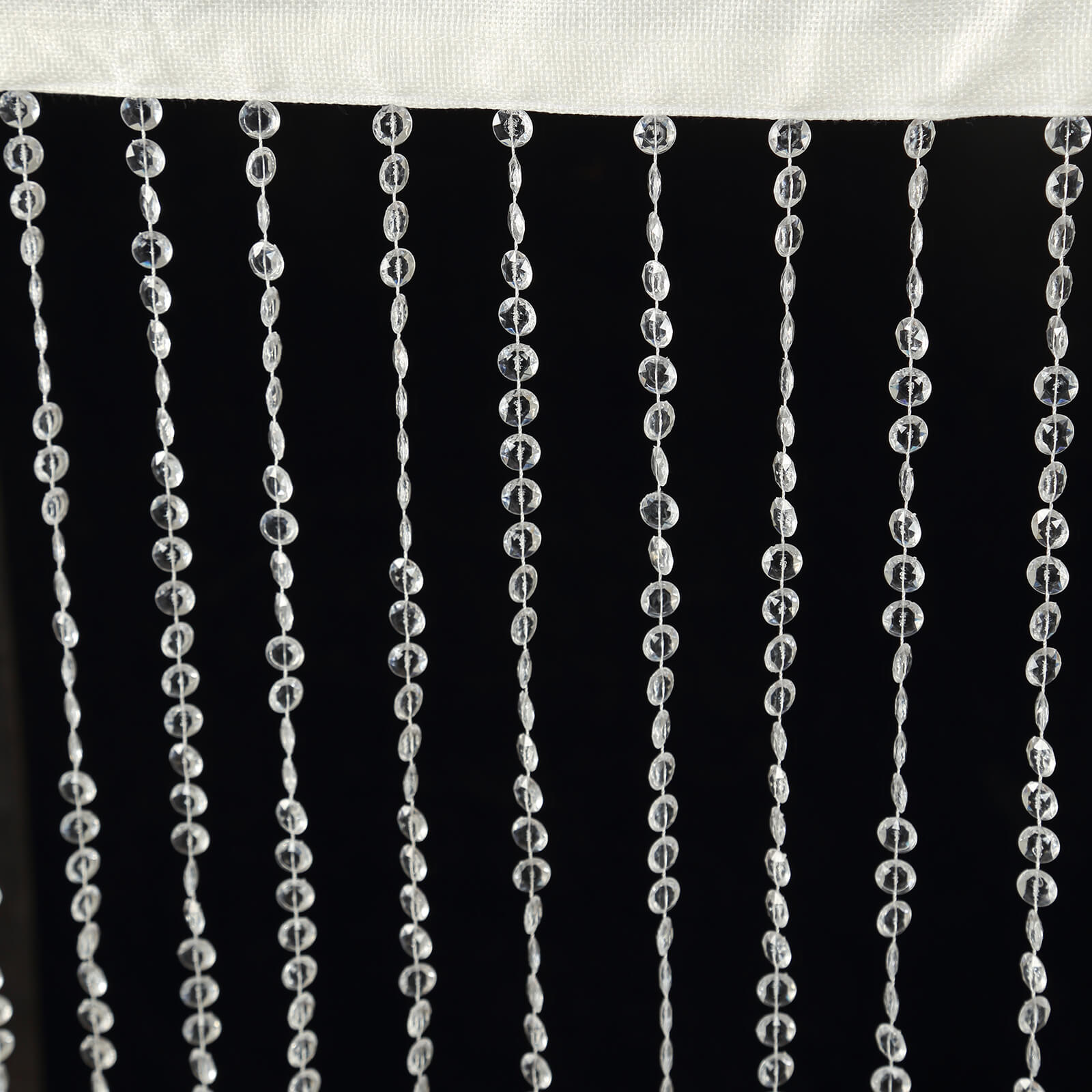 Clear acrylic crystal beaded curtain with fabric rod pocket.