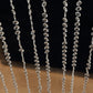 Clear acrylic beaded curtain with diamond cut beads for doorway decoration.