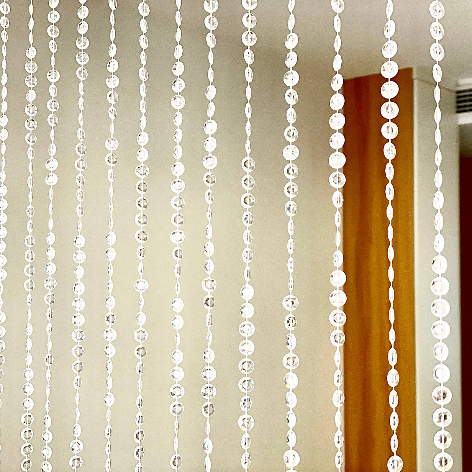 Clear acrylic beaded curtain room divider with diamond cut beads.