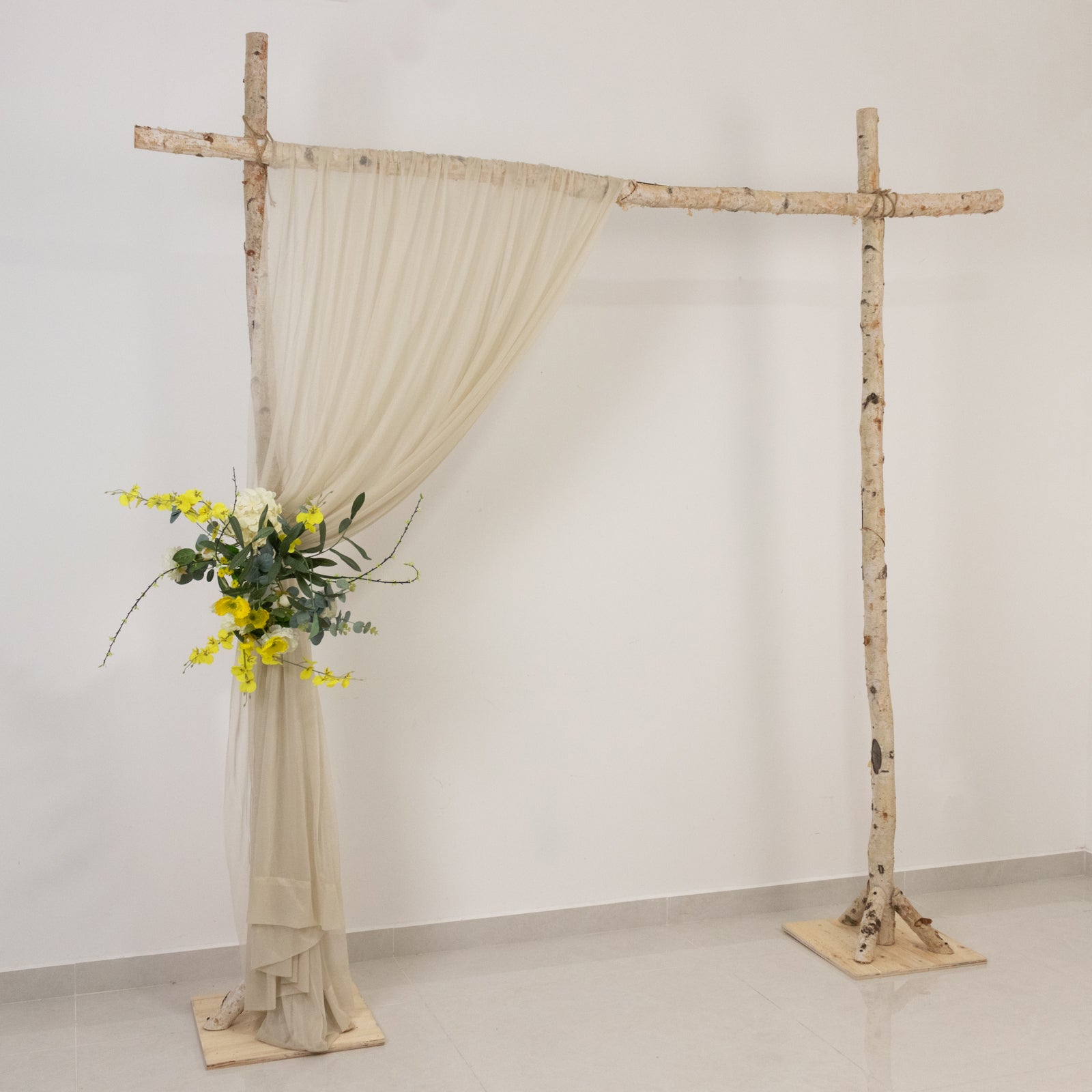 Beige sheer backdrop drape for wedding arch and ceiling decor.