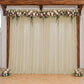 Beige sheer backdrop drape for wedding arch and ceiling decor.