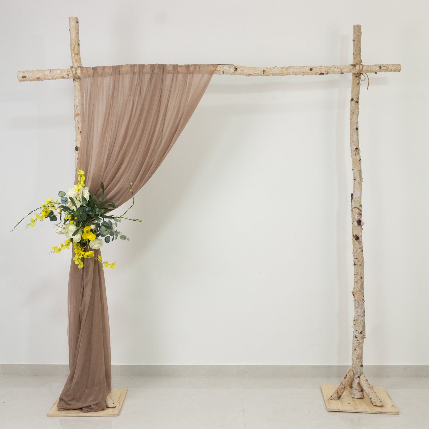 Taupe sheer backdrop drape for wedding arch and ceiling decor.