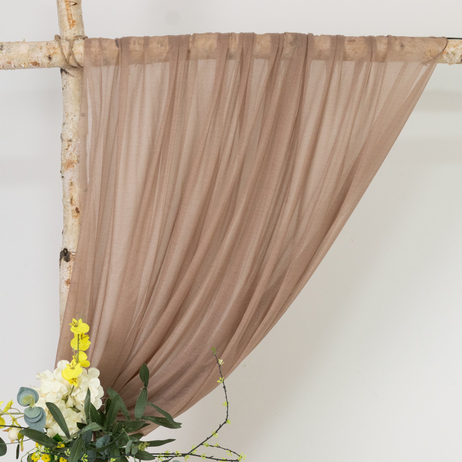 Taupe sheer backdrop drape for wedding arch and ceiling decor.