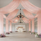 Blush sheer backdrop drape for elegant wedding arch and ceiling decor.