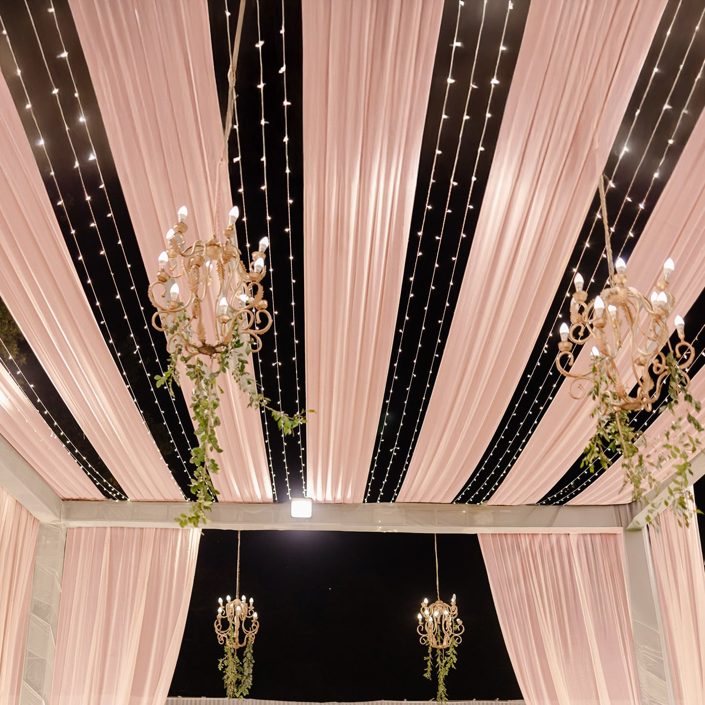 Blush sheer backdrop drape for wedding arch and ceiling decor.