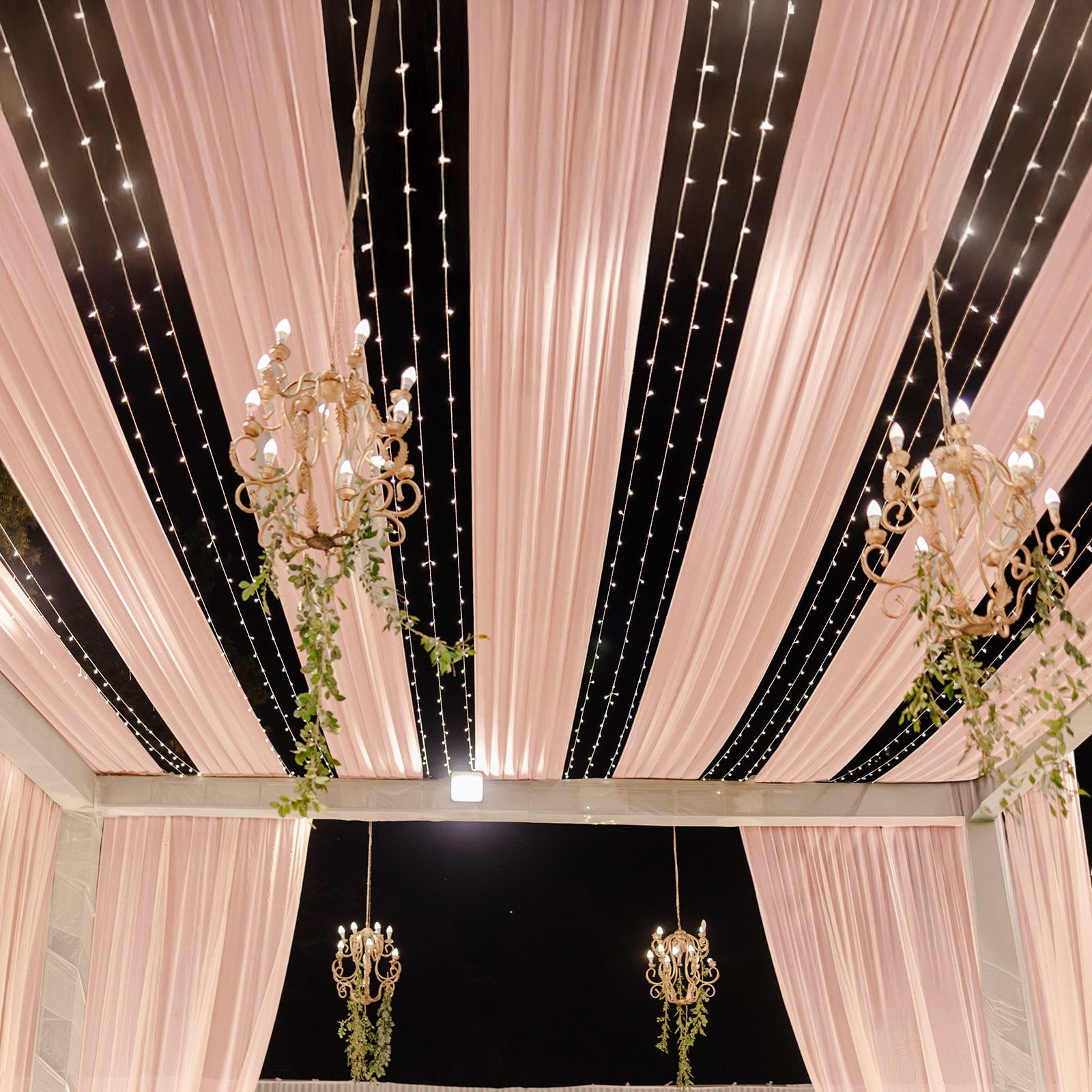 Blush sheer backdrop drape for wedding arch and ceiling decor.