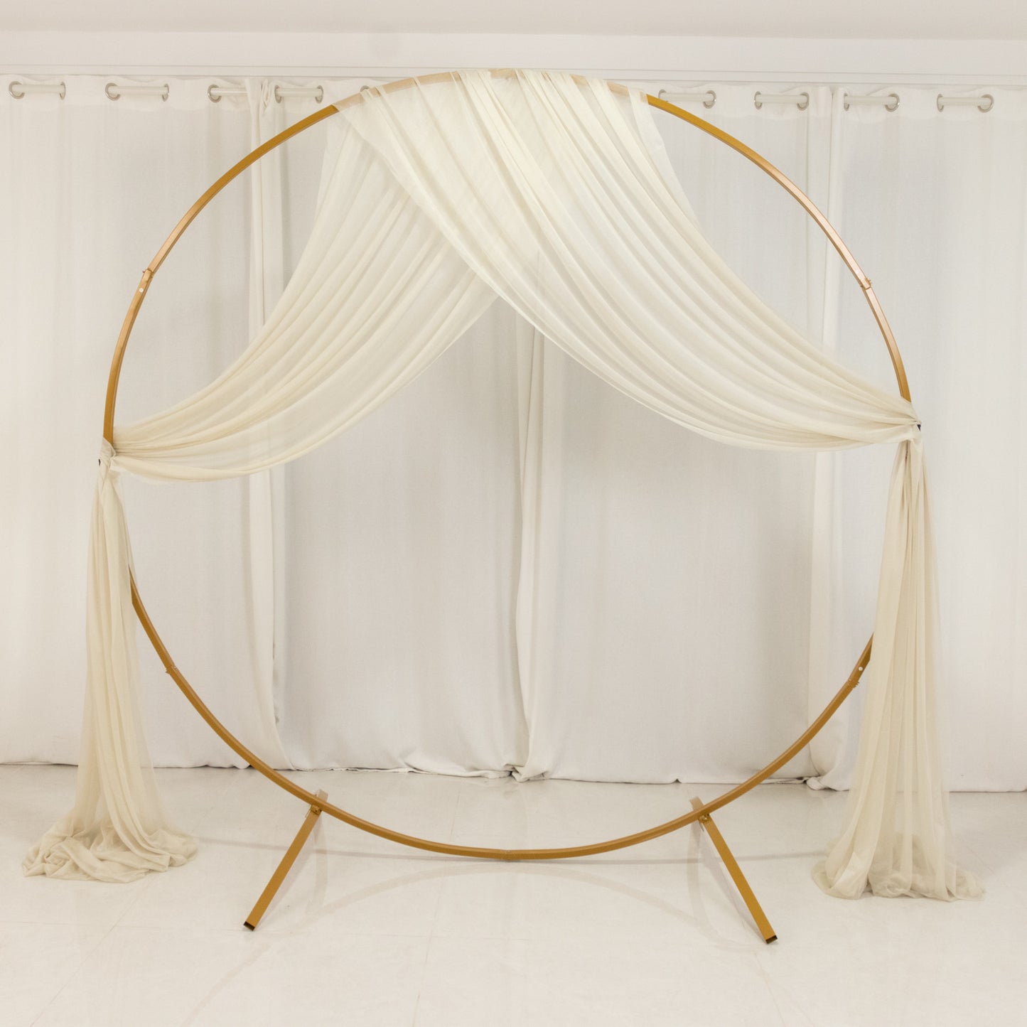 Beige sheer backdrop drape for wedding arch and ceiling decor.