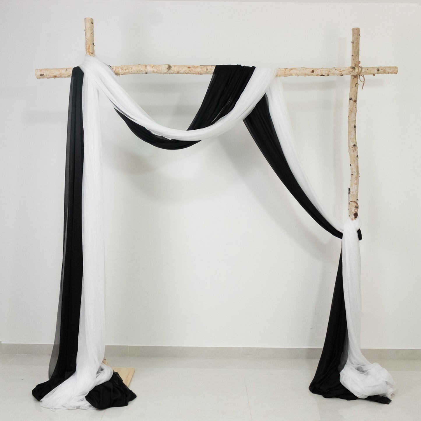 Black sheer backdrop drape for wedding arch and ceiling decor.
