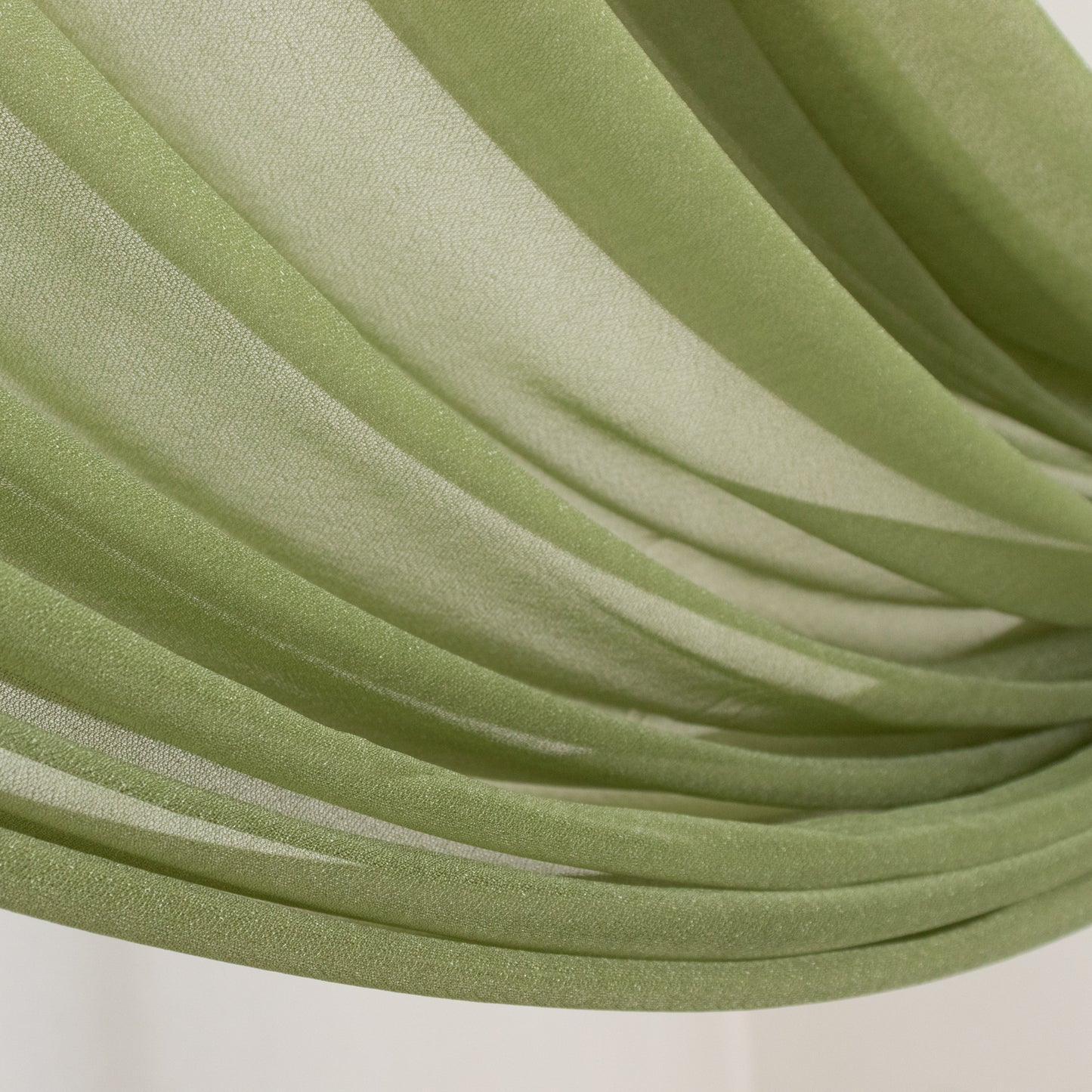 Dusty sage green sheer backdrop drape for wedding arch and ceiling decor.