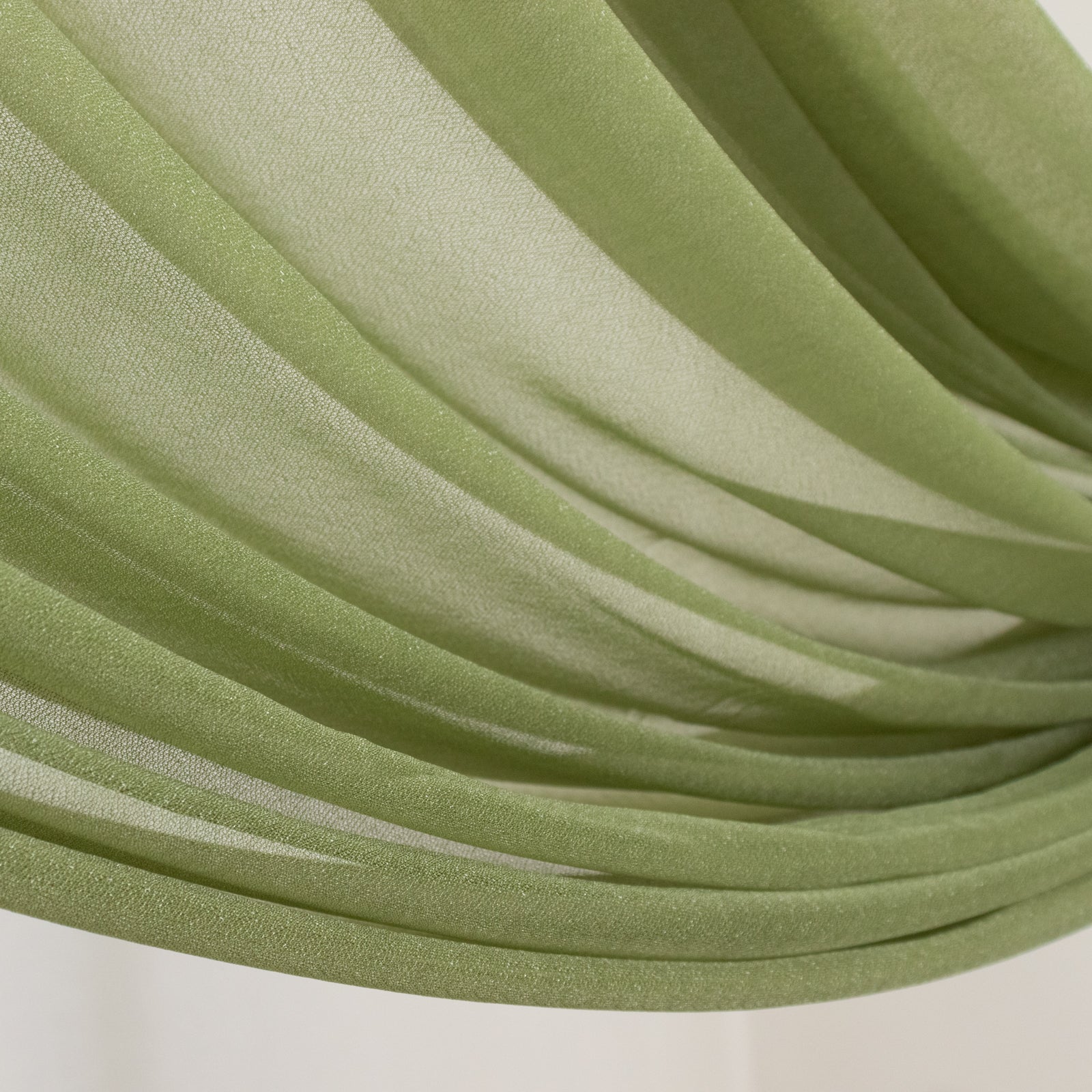 Dusty sage green sheer backdrop drape for wedding arch and ceiling decor.