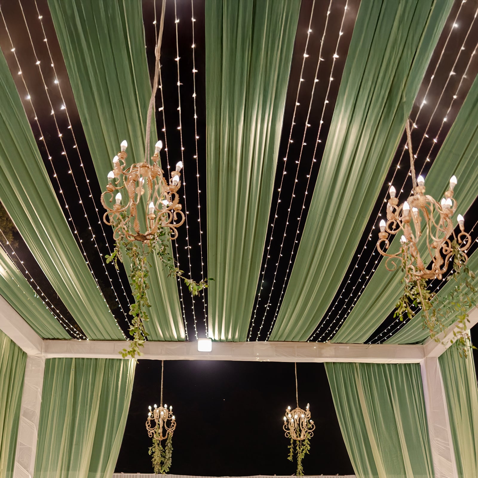 Dusty sage green sheer backdrop drape with soft shimmer for wedding decor.