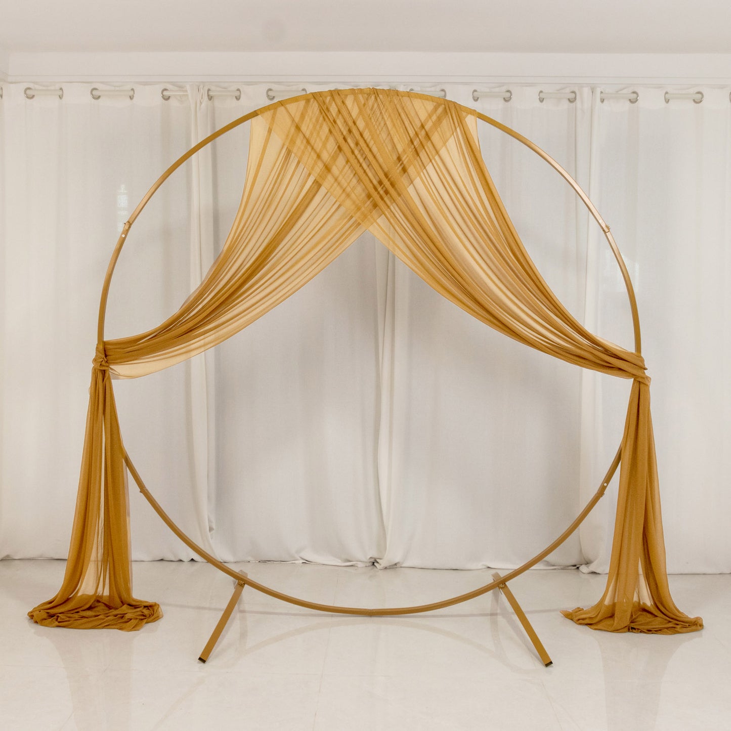 Gold sheer backdrop drape for wedding arch and ceiling decor.