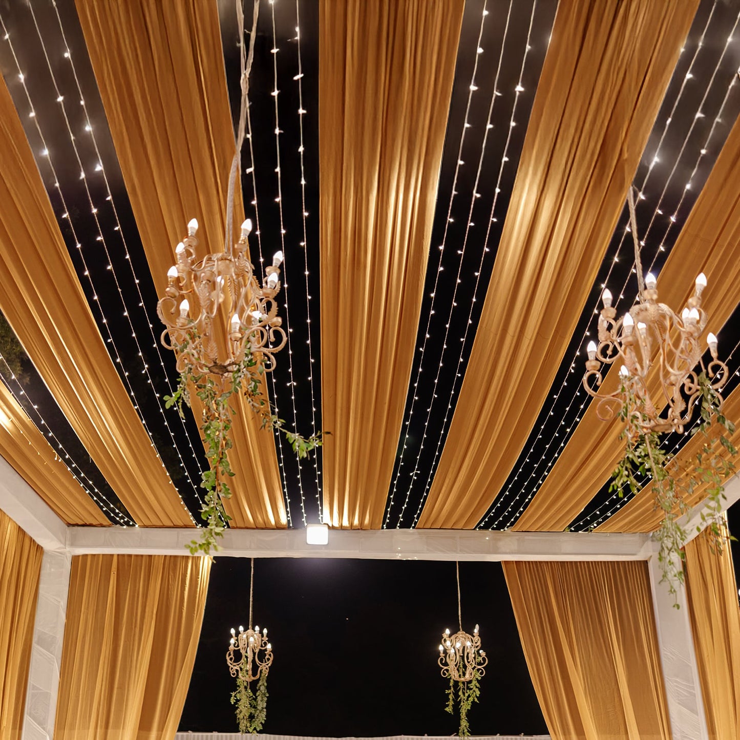 Gold sheer backdrop drape for wedding arch and ceiling decor.