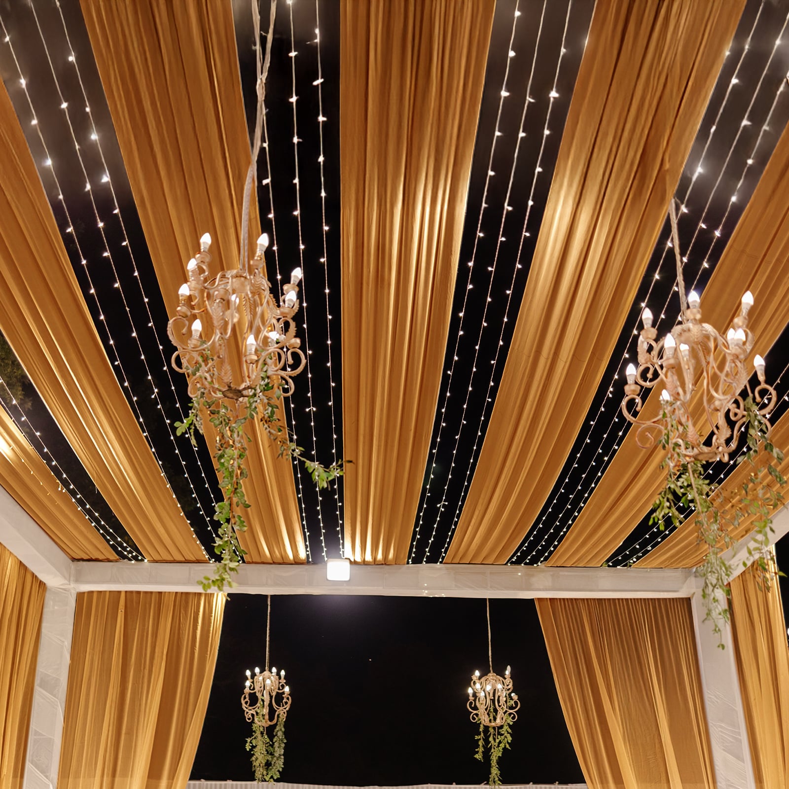 Gold sheer backdrop drape for wedding arch and ceiling decor.
