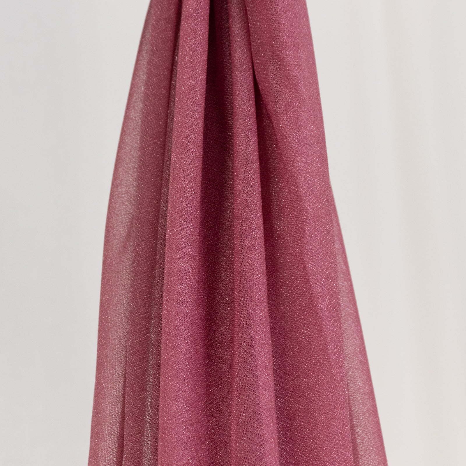 Mauve sheer backdrop drape with soft shimmer for wedding decor.