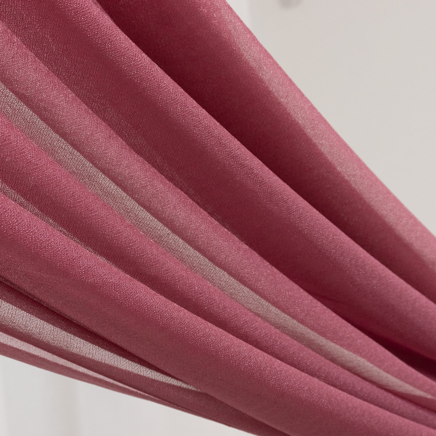 Mauve sheer backdrop drape for wedding arch and ceiling decor.