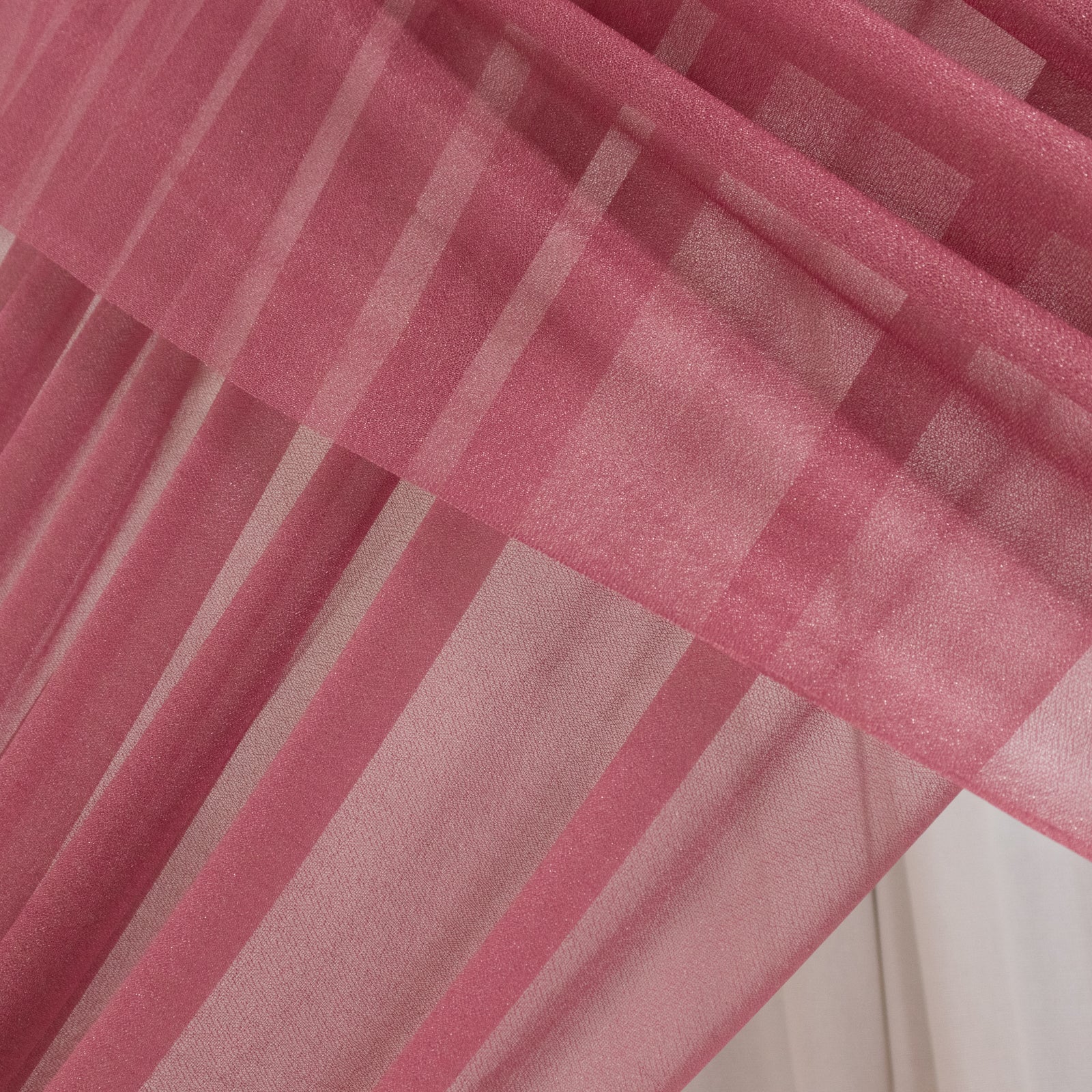 Mauve sheer backdrop drape for wedding arch and ceiling decor.